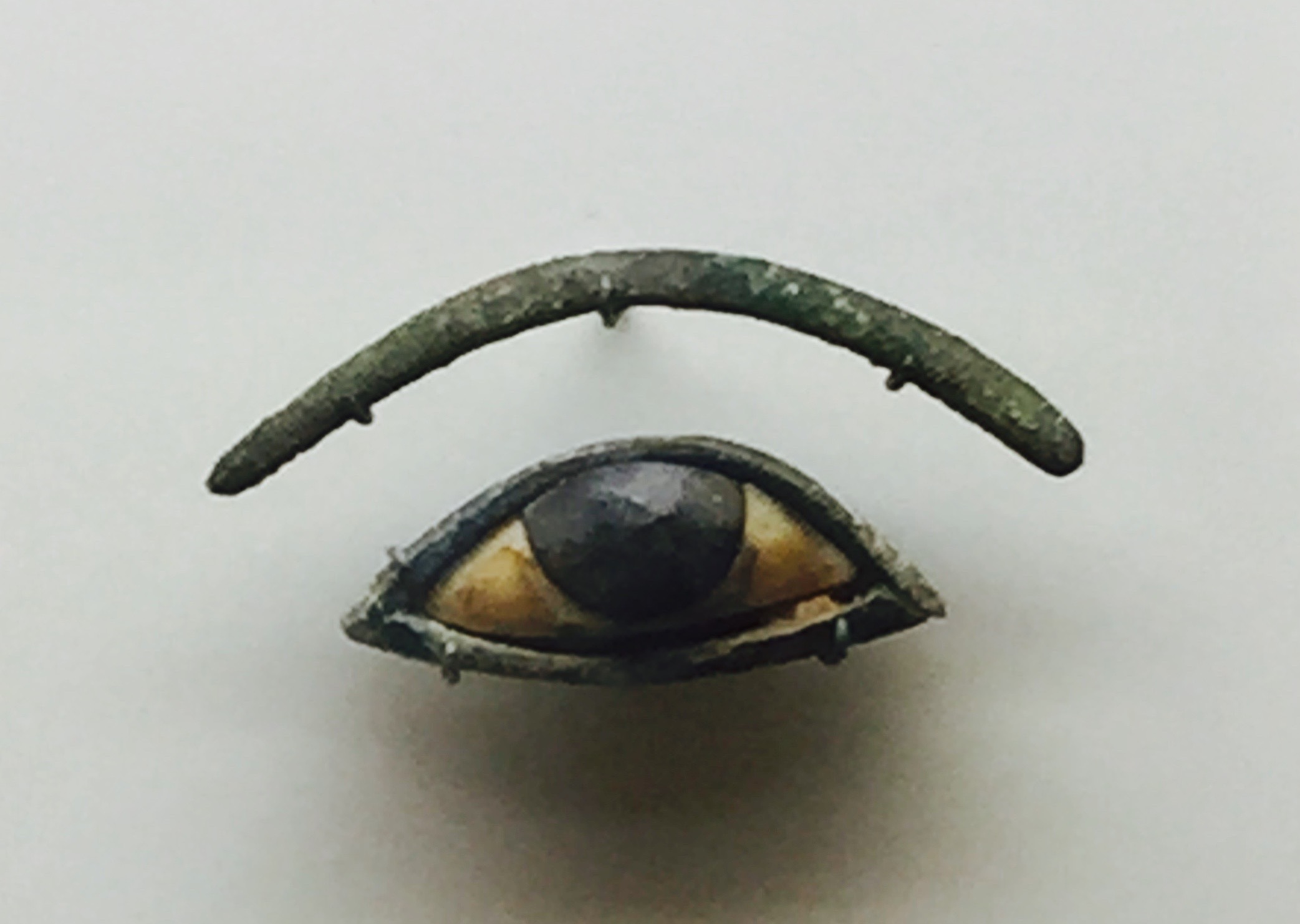 Eye and Eyebrow inlays. 1293 to 715 BCE. Ivory, Obsidian and the eyebrow is bronze.