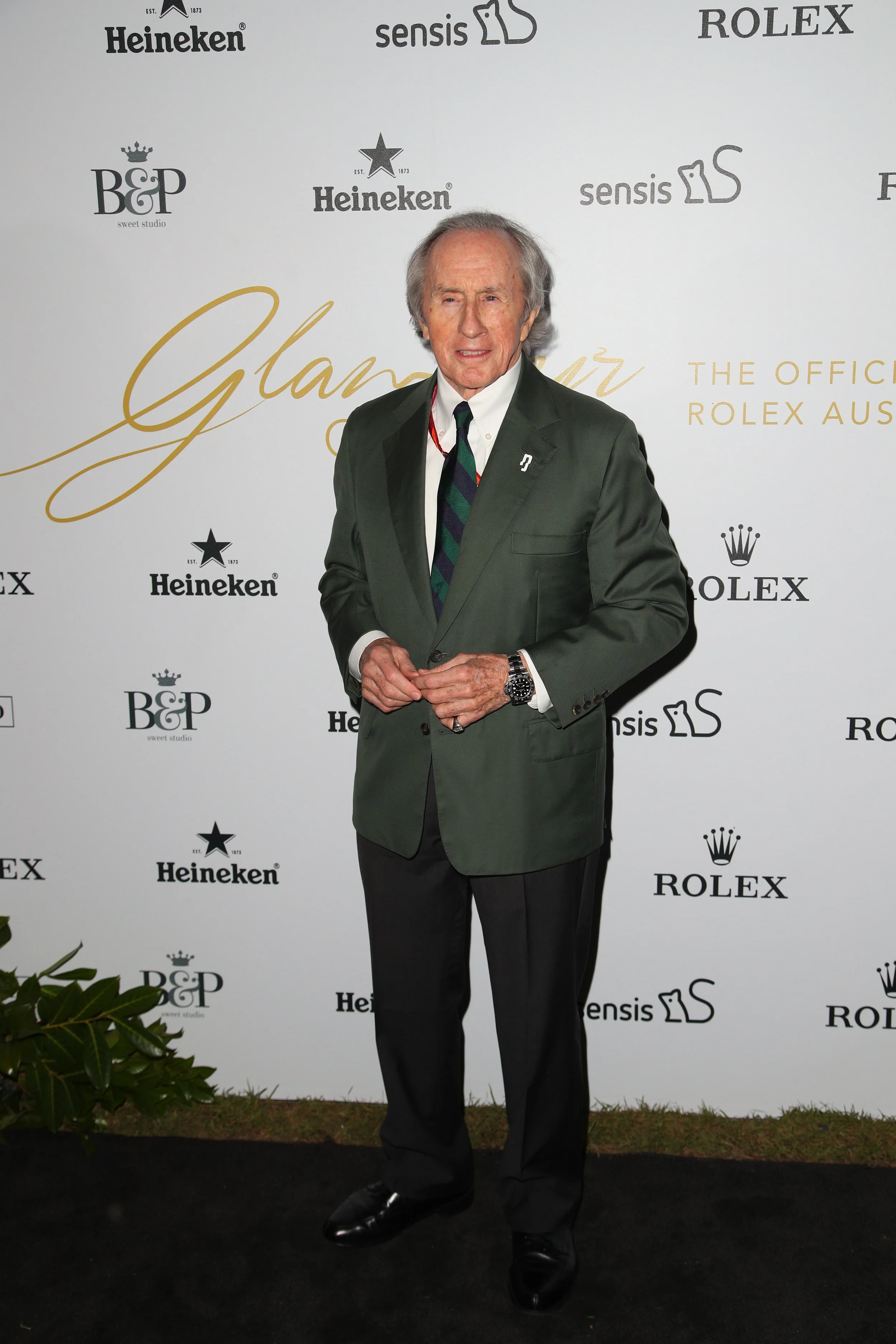 Sir Jackie Stewart on the media wall with Burch & Purchese branding at the 'Glamour on the Grid' launch party for the 2017 Australian Grand Prix at Albert Park.