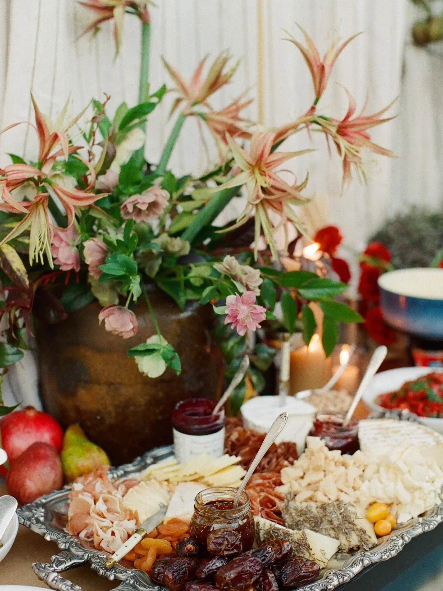 A grazing spread like this turns cocktail hour into an experience &mdash; where guests gather, snack, and settle into the celebration before the night unfolds.

Layered florals, vintage trays, and abundant bites create that effortless European-garden