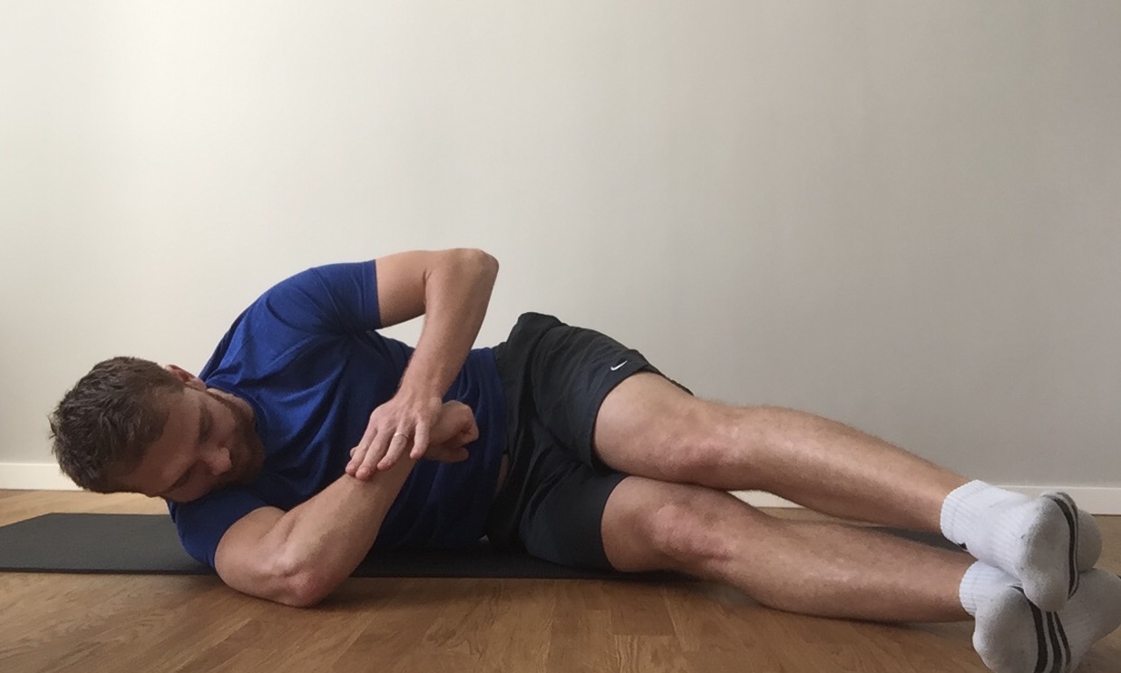 Isometric contraction against hand.