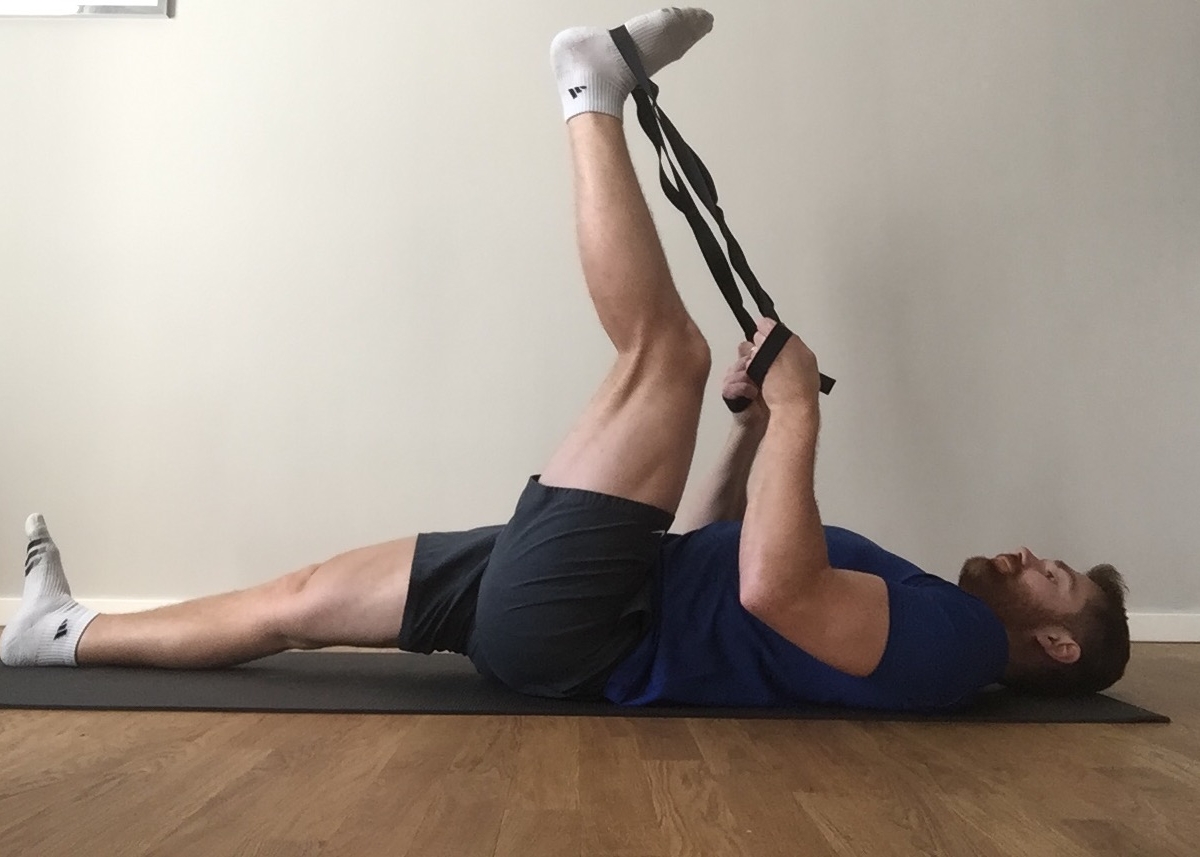 Use a stiff stretching rope, towel or a similar apparatus to perform the stretch.