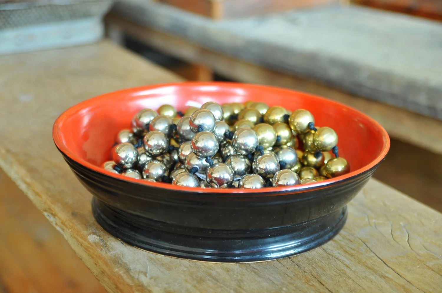 Metal beads in a Cambodian lacquer offering tray