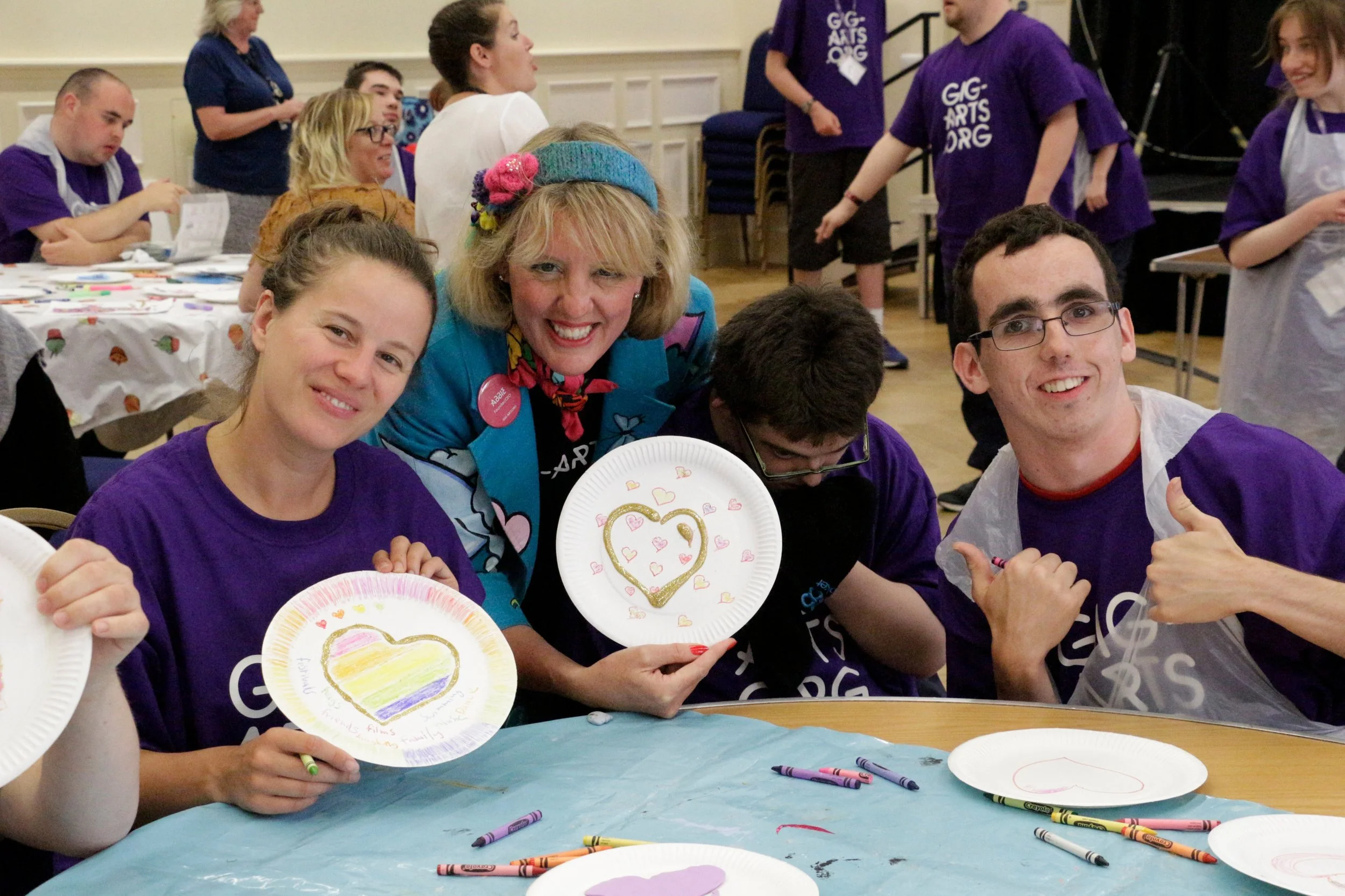 Grace and Abbie work with the teams to create love heart artworks to give to the community.