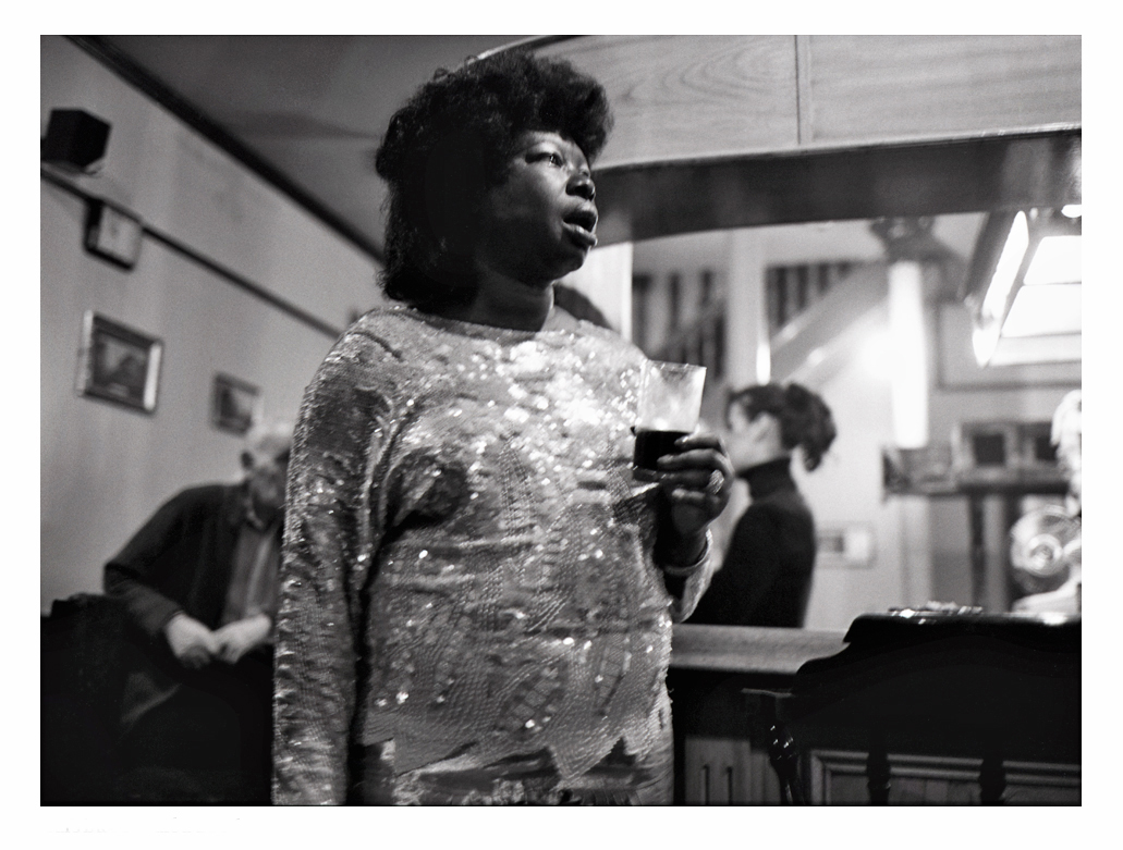She sensed our disappointment, stood up and began to sing in that big empty bar. A part of me inside faded.