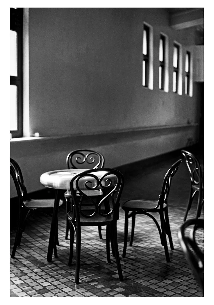 The floor was a resin poured over wooden blocks in a circular pattern. The Tables were designed specifically for the refurbishment and made of aluminium. The chairs by Thonet.