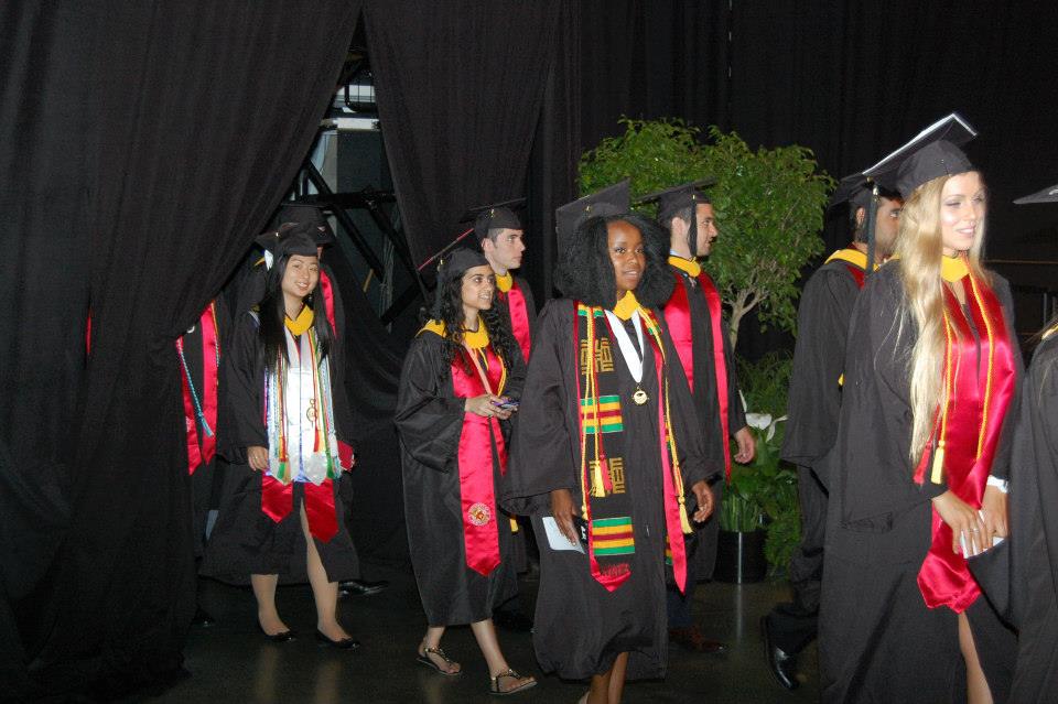 ILS students walking in graduation regalia.