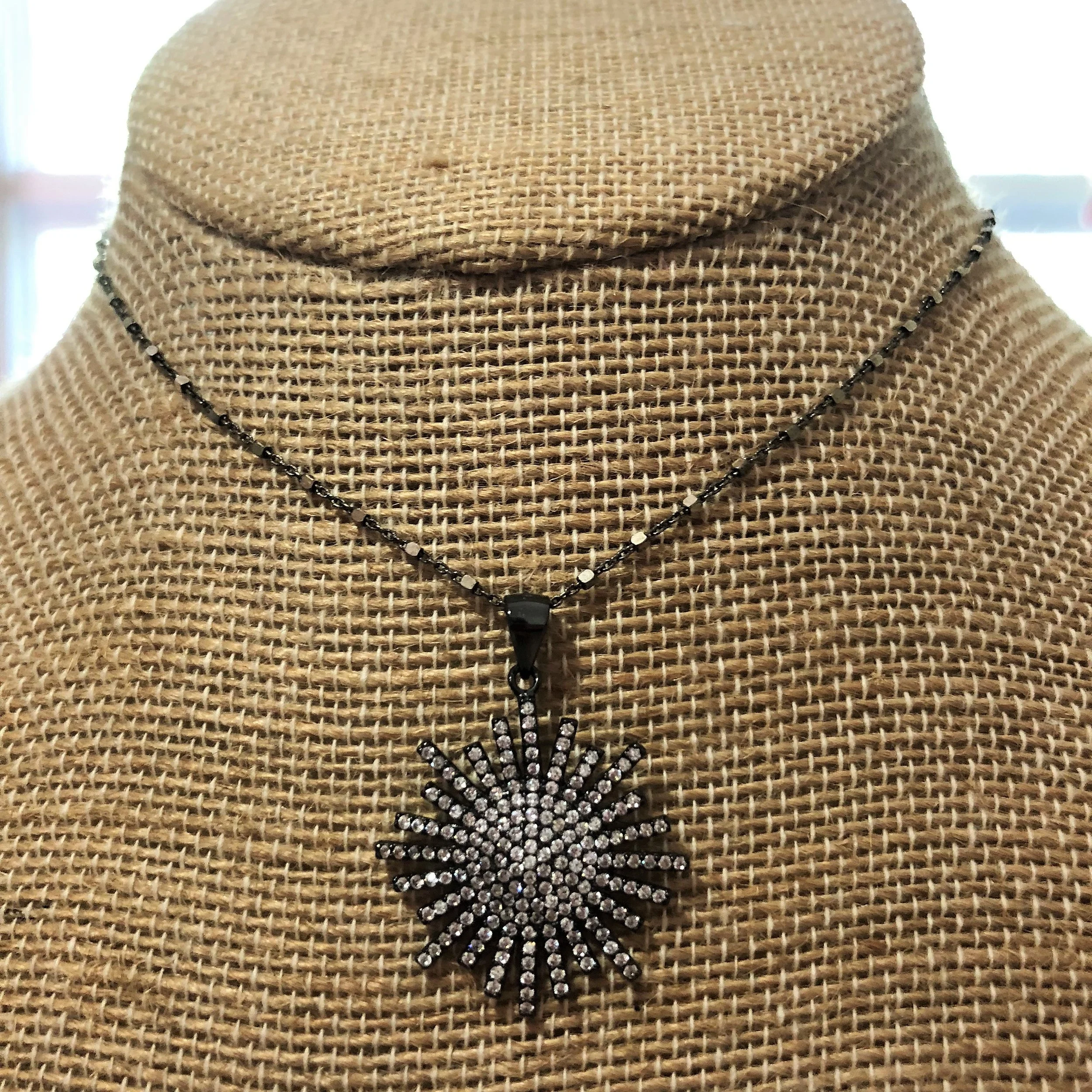Starburst pendant on blackened silver chain
