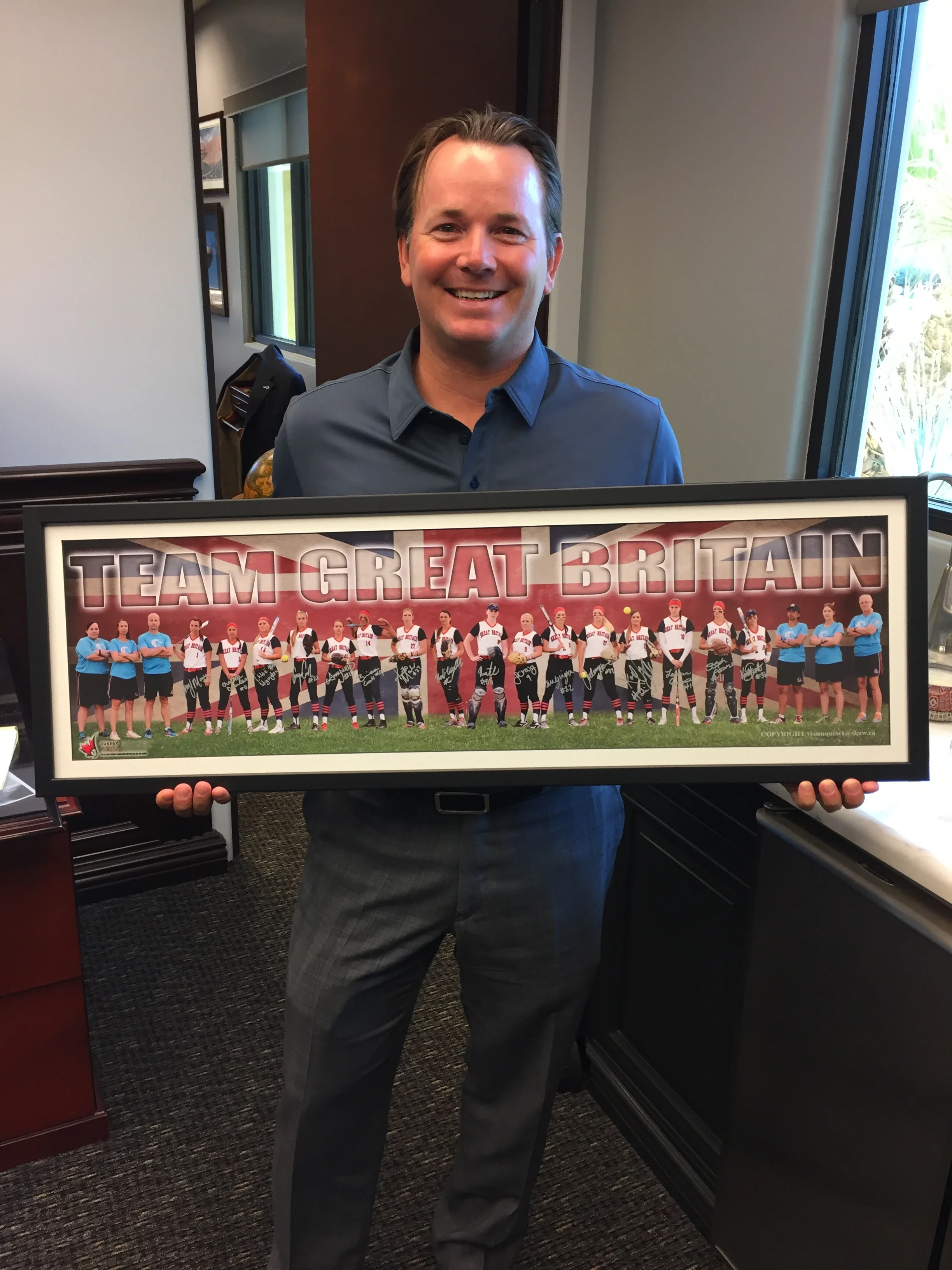Walter Neil shows off his signed team photo.