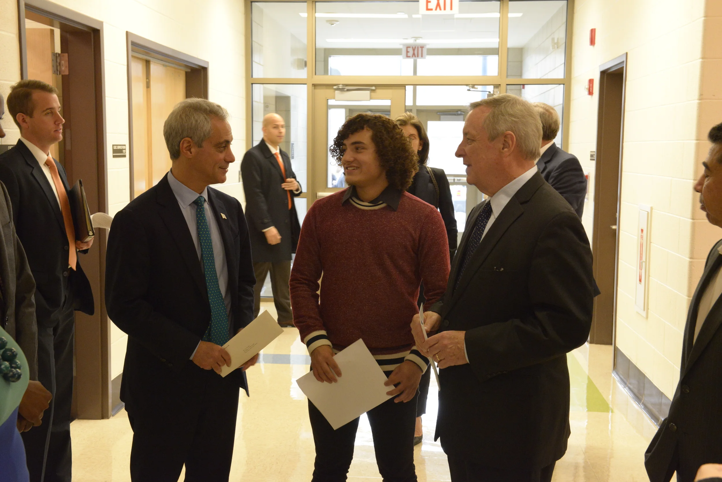 A Benito Juarez student ambassador greets Mayor Rahm Emanuel and Senator Dick Durbin