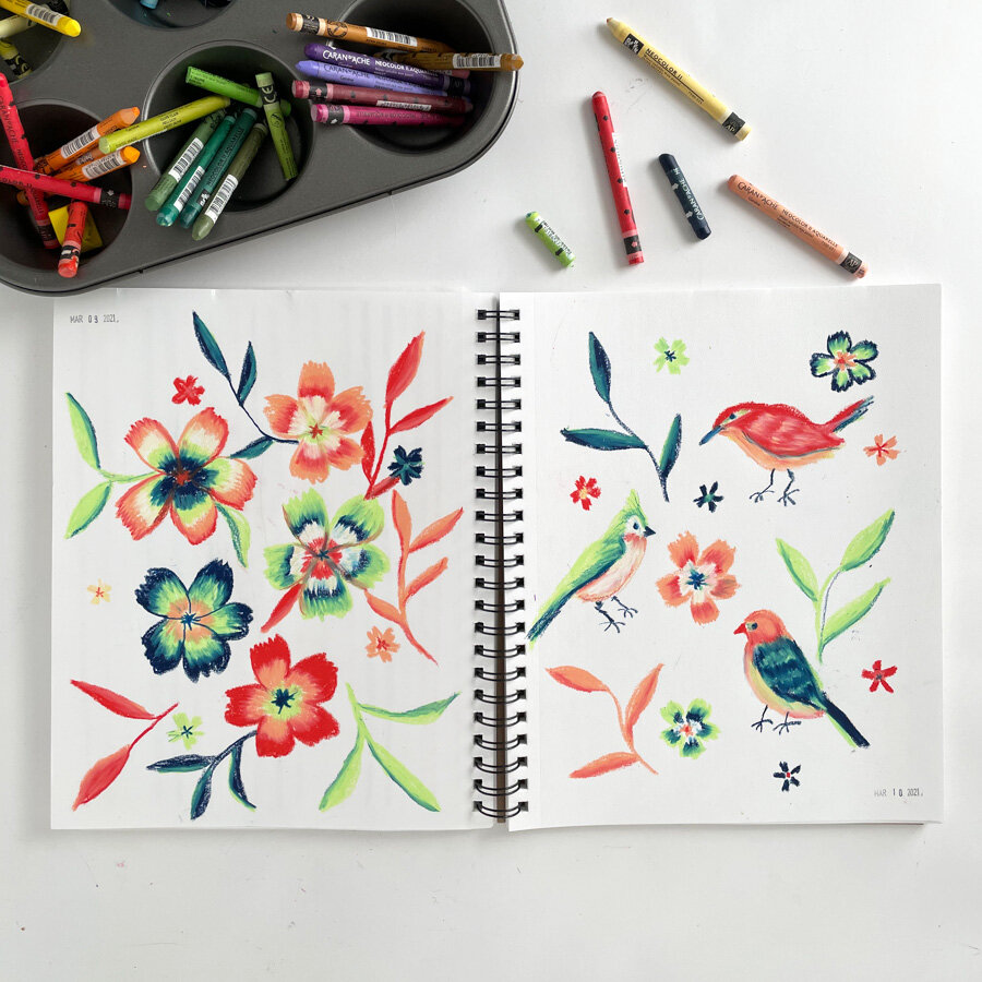  A page of playful sketchbook page of flowers and birds done in crayon in a fanciful color palette. 