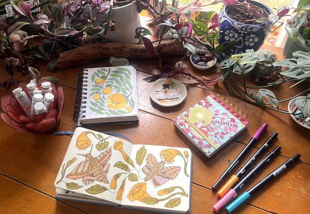Artist Kim Koehler's desk with her beautiful sketchbooks and lots of inspiration