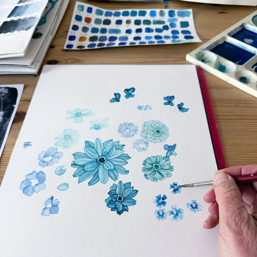 Anne Butera painting a botanical watercolor all in blues depicting the dream of her future garden