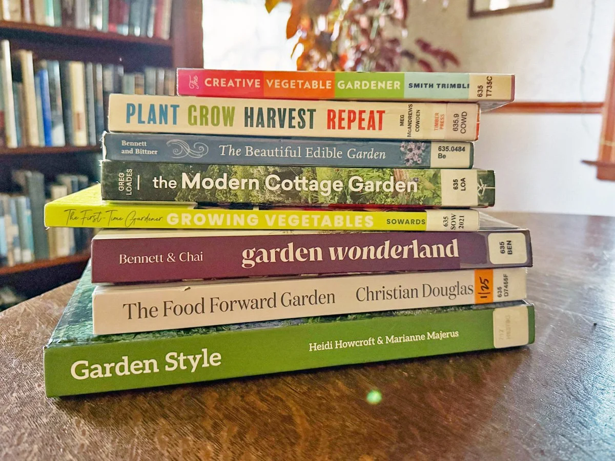 a stack of garden books from the library