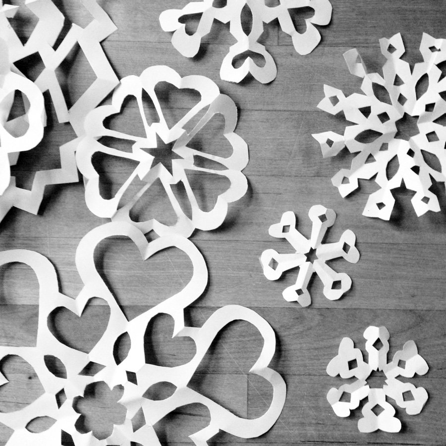 paper snowflakes on a table in black and white