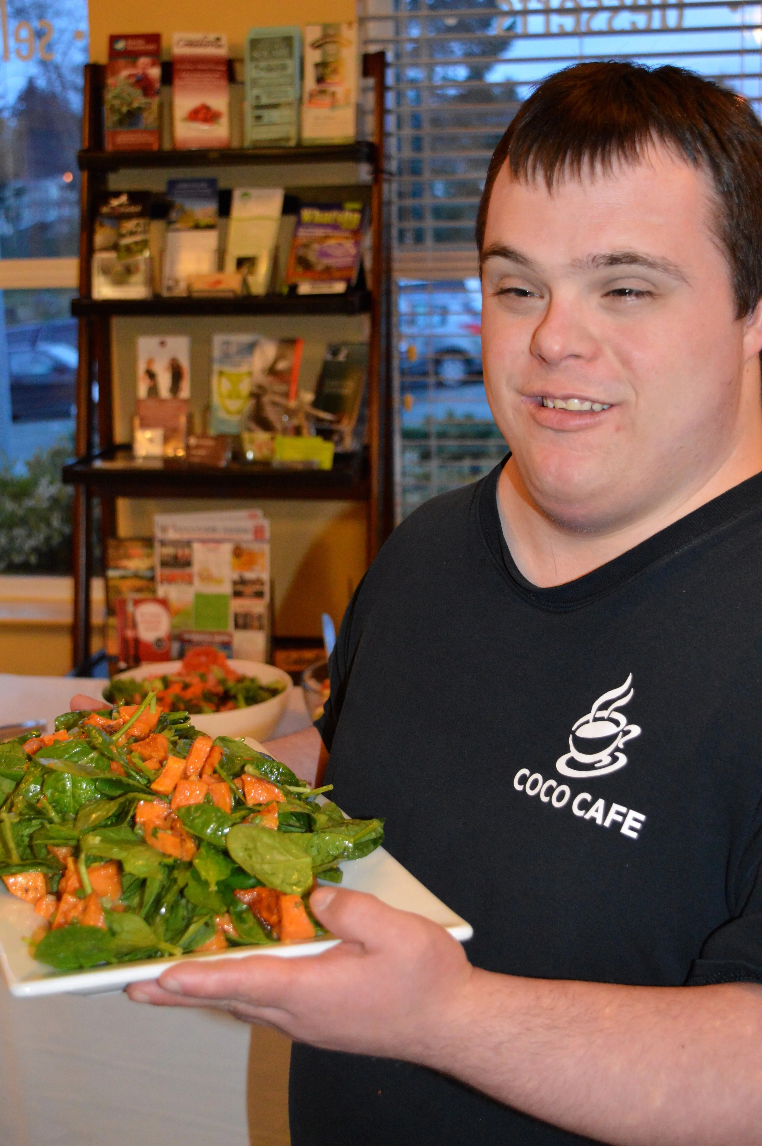 Mark serving our Roasted Yam & Spinach Salad