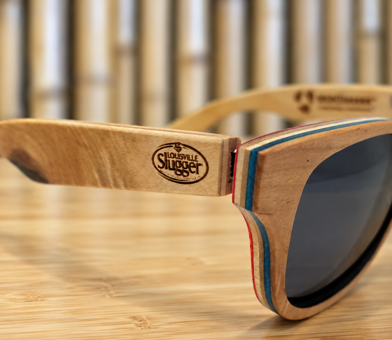 Custom laser-engraved promotional wood sunglasses featuring a Louisville Slugger logo.