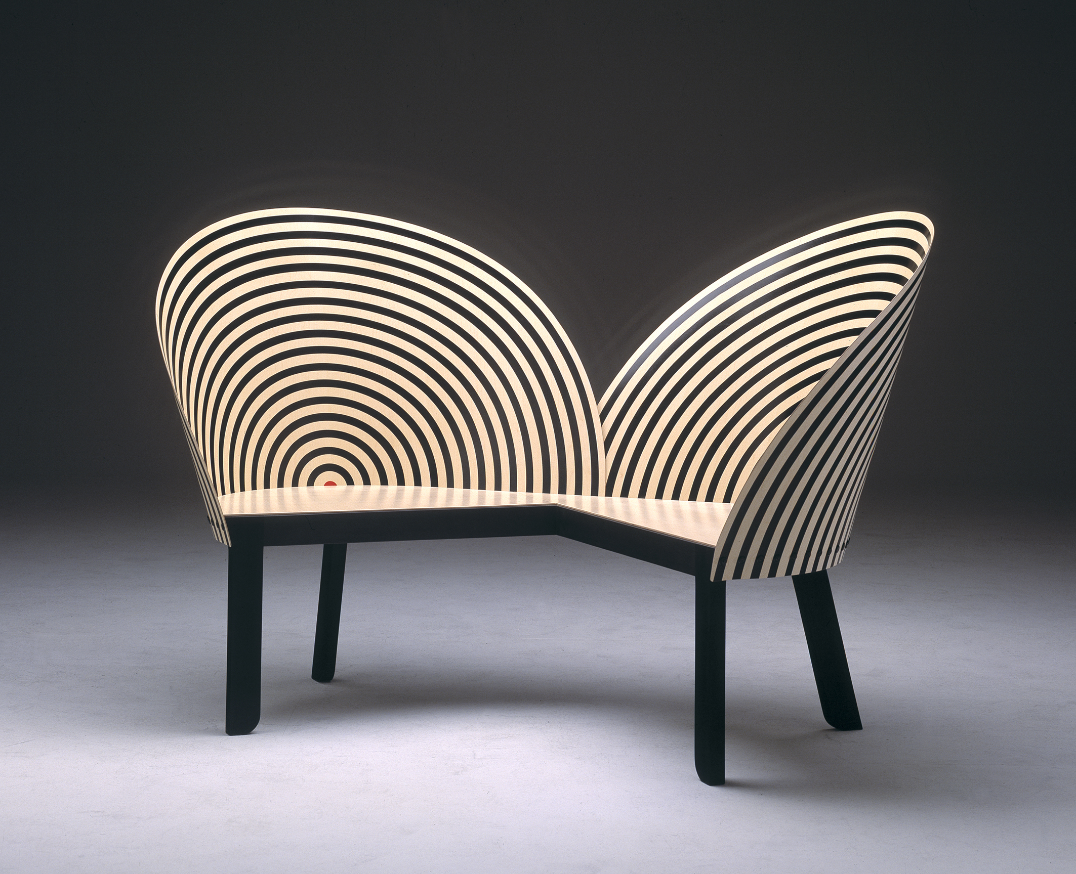 Nanna Ditzel, Bench For Two (1989) Ditzel, otherwise known as the "First lady of Scandinavian Design", like other women in her generation, came up during time when the field was mostly male dominated. Trained as a cabinetmaker at the Royal Academy of Fine Arts, her work was multifaceted to include jewelry, ceramics and textiles. Read more of her story HERE