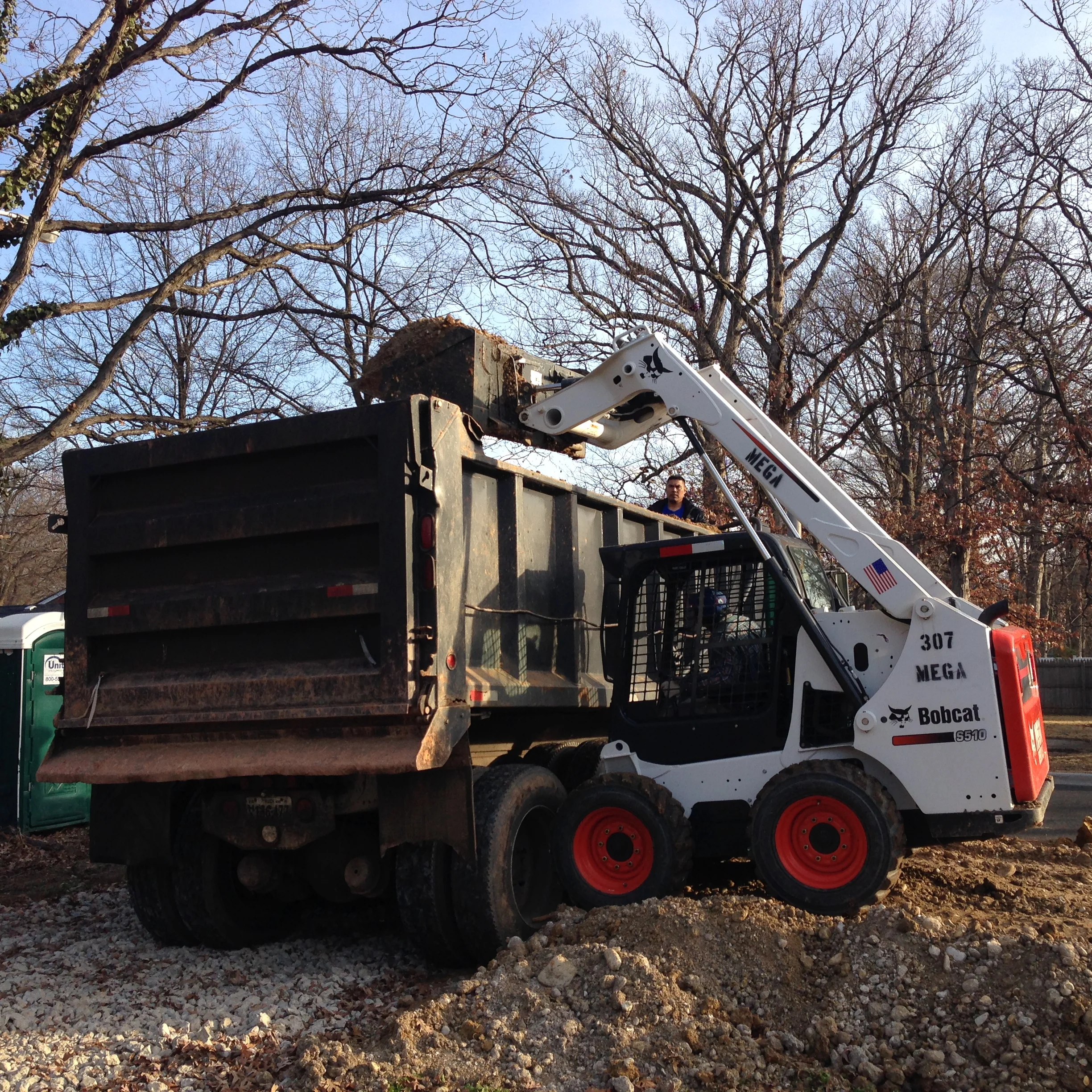 A temporary ramp was made for the Bobcat to be able to load into the dump truck.
