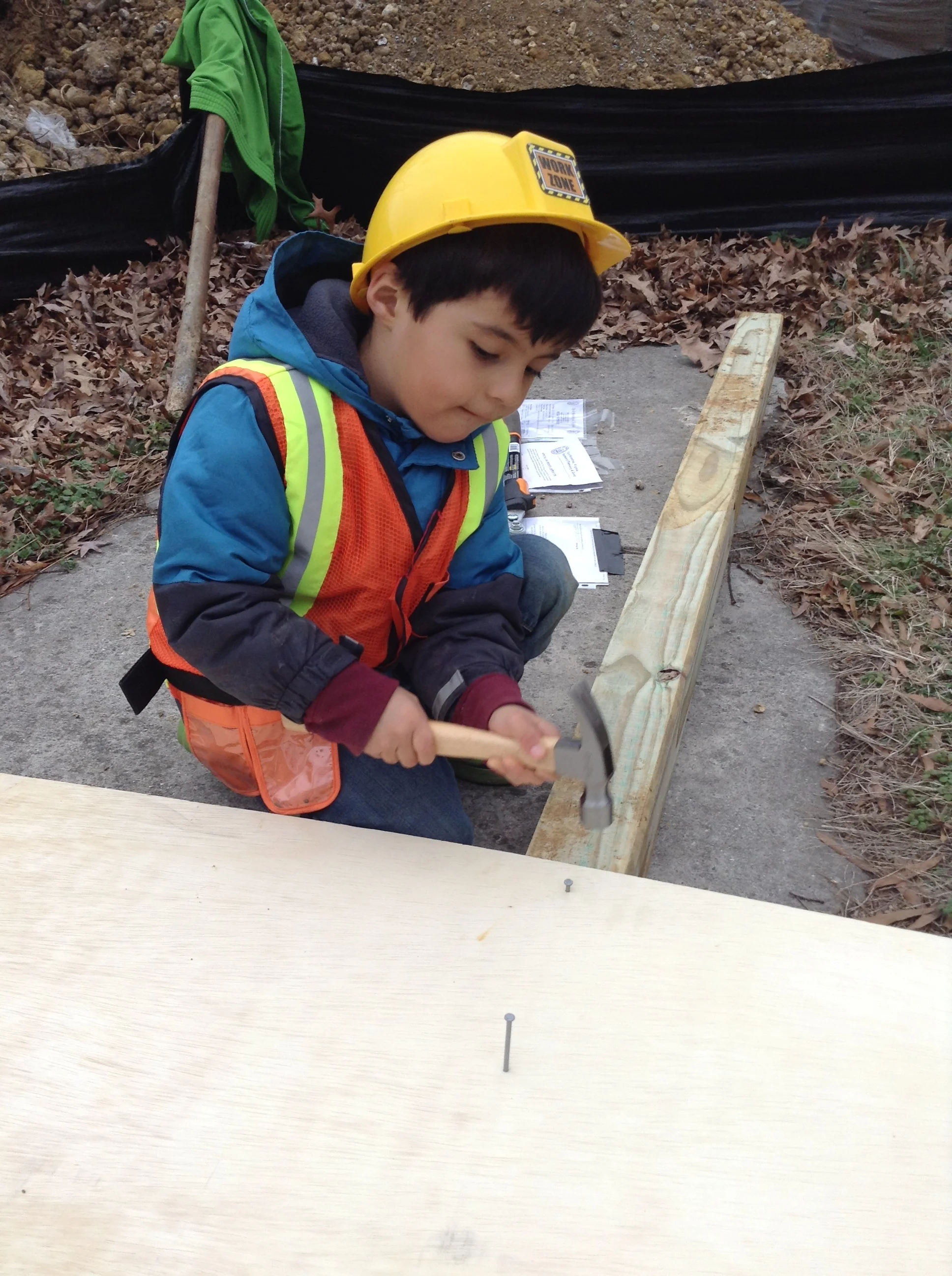 Always wearing a hard hat and vest for safety. We don't want OSHA to get mad at us.