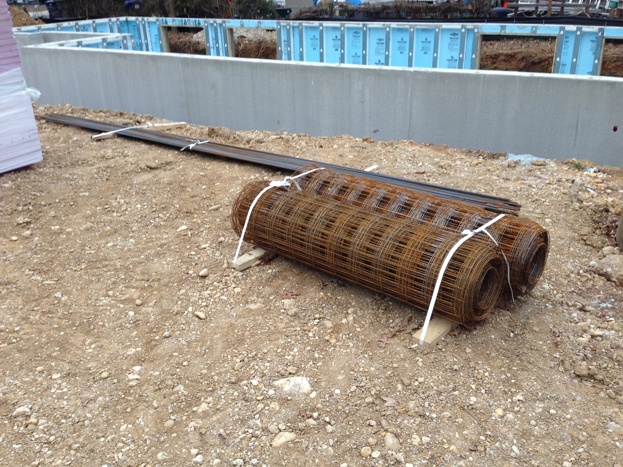 Some materials for under the slab. R10 insulation on the left, rebar for the footing and steel mesh for the slab.