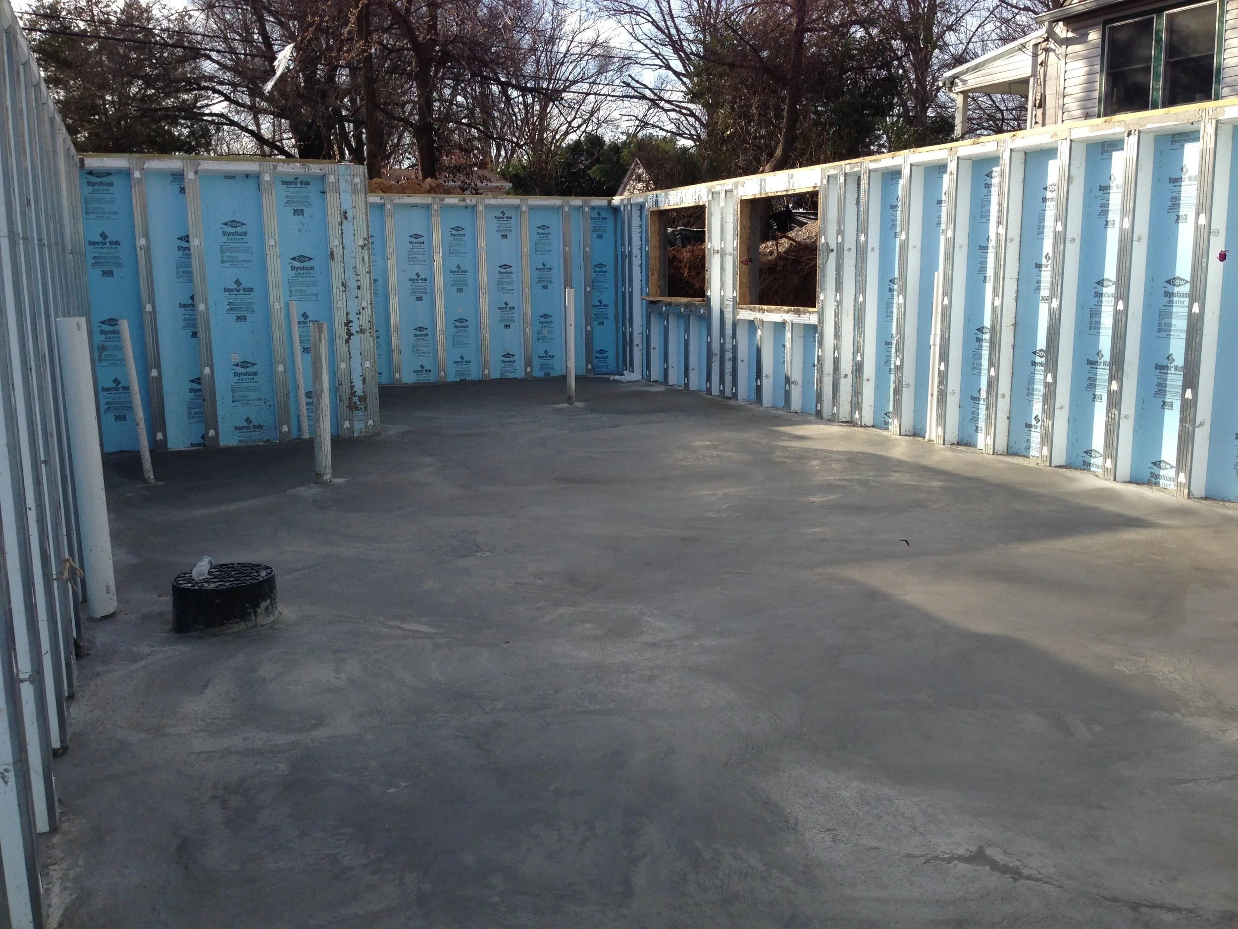 Basement slab poured. The reason we settled on the slab height was that per code it has to be 44" from the bottom of the window to be considered an egress window.