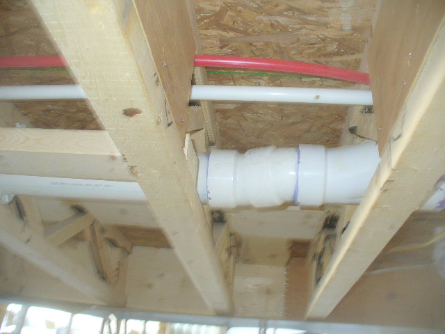 Some plumbing and wiring installed in the factory. Notice the use of a truss rather than a standard joist. This allows for pipping and wiring to be easily installed.