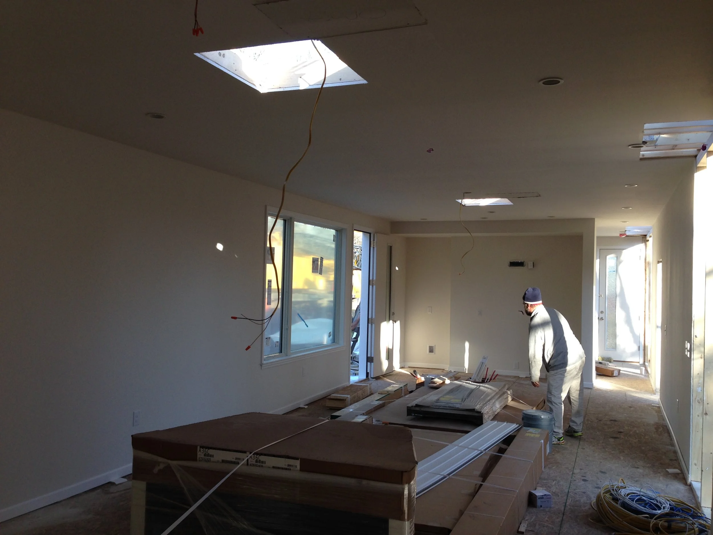 14:50 - Sneak peak at the main living space. I'm standing in the living room, the guy is in the dining room and at the end is the kitchen. Excel Homes could have provided all the cabinets and flooring but we did not have enough time to pick custom materials. Event though the house was installed on site today it was actually built back in mid-January.