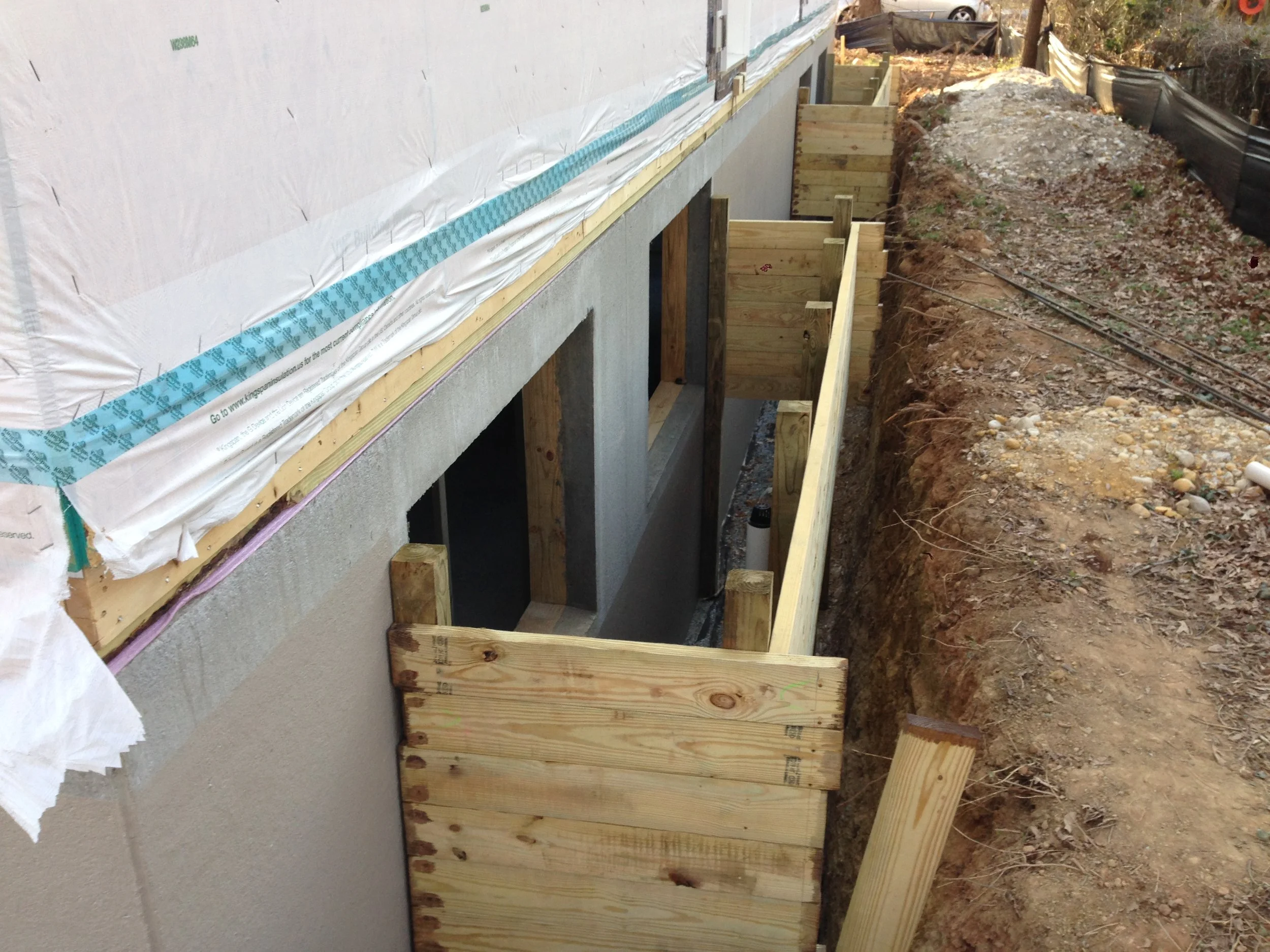 Two window wells. This could have easily been completely in a day. Once we back fill and complete the siding we will stain the wood. We will soon have a fun filled basement. 