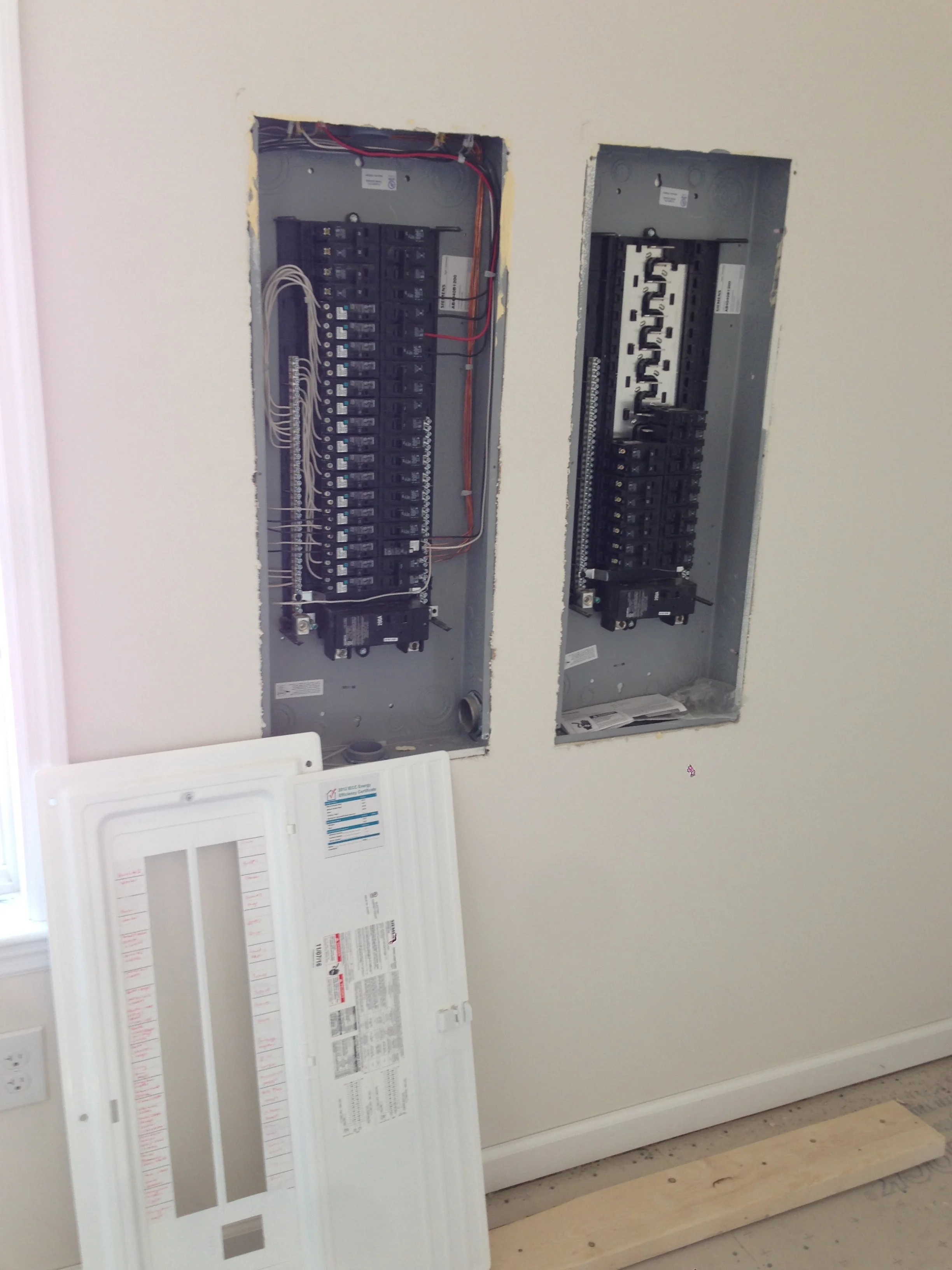 Electric Panel removed. The one on the left are for the first two floors as provided by Excel all pre-wired. The right panel is for the basement and any other items added on site.