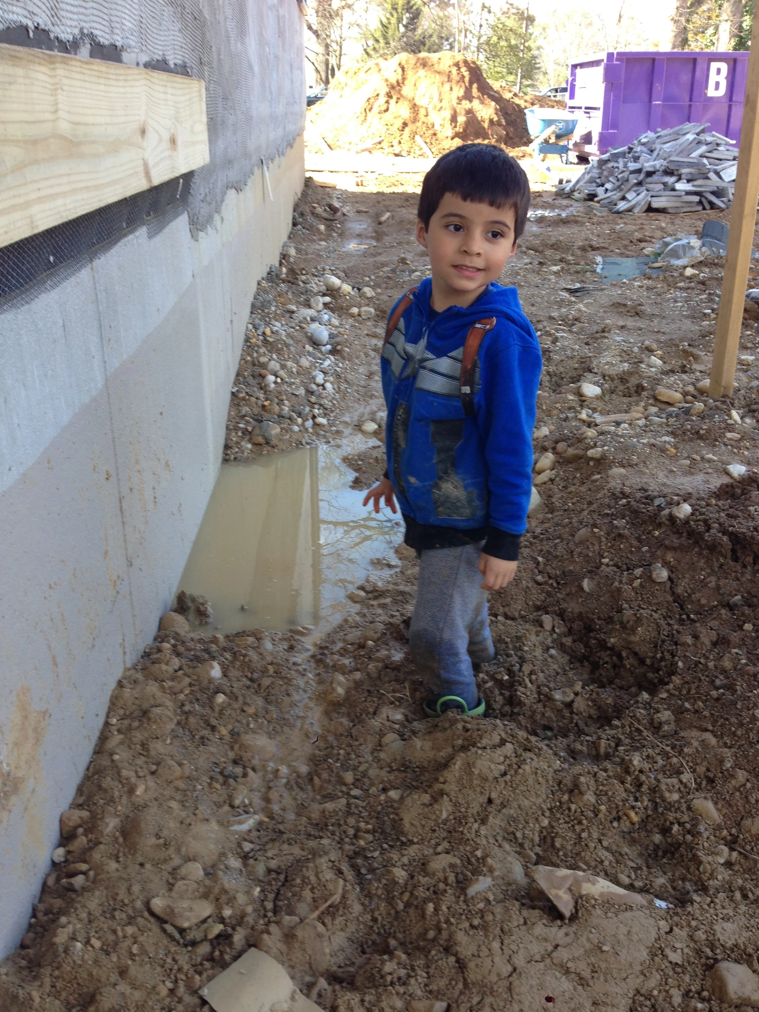 As promised Pedro playing in the mud and getting stuck. No that water in the photo is not good. We need to backfill properly ASAP. 