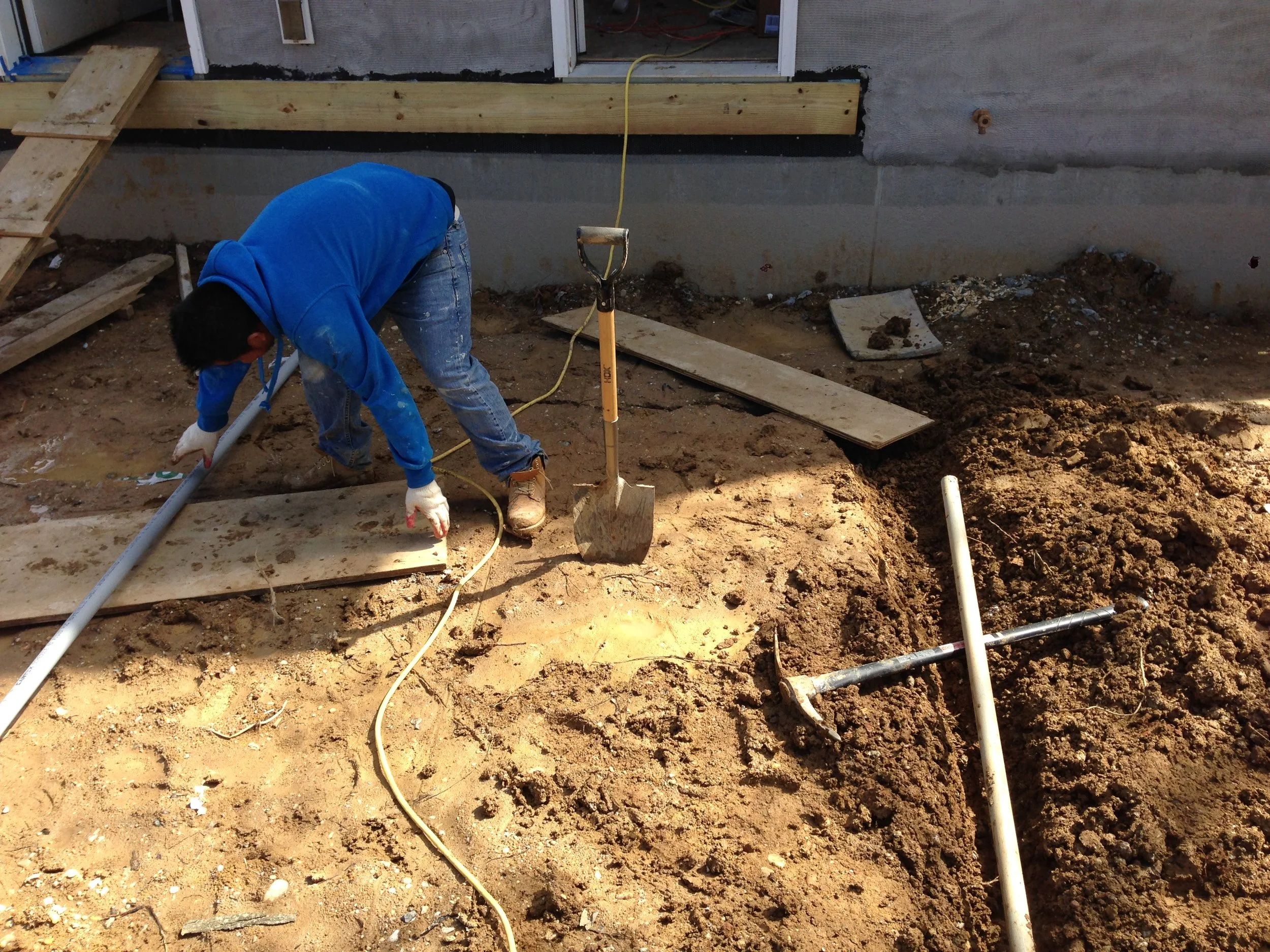 Installing the electric conduit to take the wiring from the house to the detached garage.