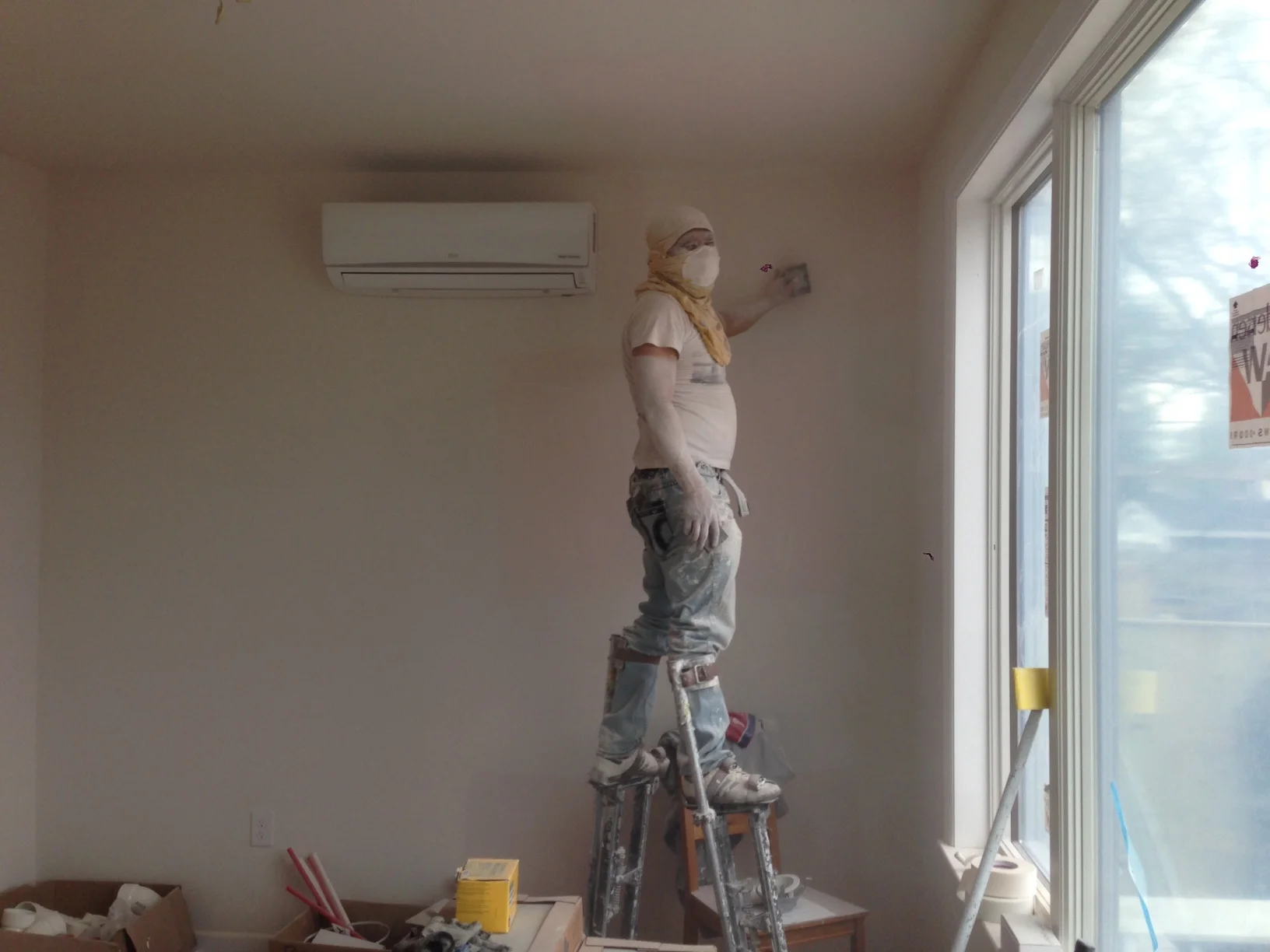 Hugo the drywall installer sanding all the patches from last week. This is not a fun job. There was dust everywhere! He did a good job but it can't be fun. Luckily he covered everything and was there before the rest of the crew showed up.