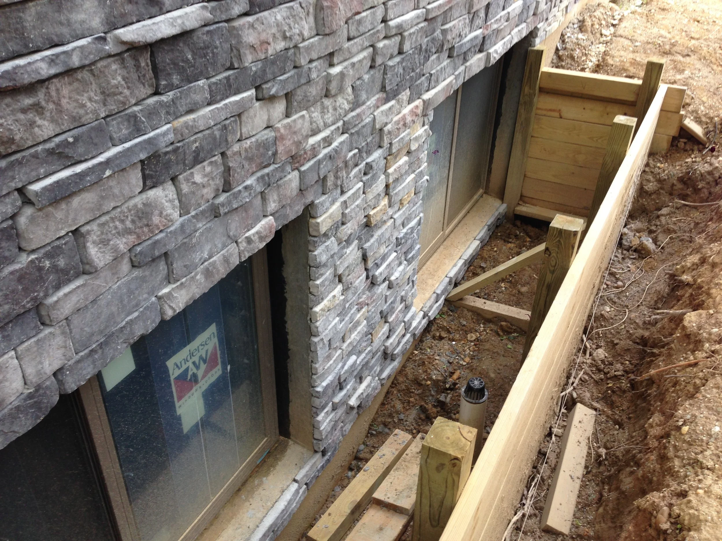 Stone all installed except for the ledger. I now need some wood to place around the window. I will do that after we back fill the hole. Yes this is on the backside of the house but I despise it when people get cheap on the back. 