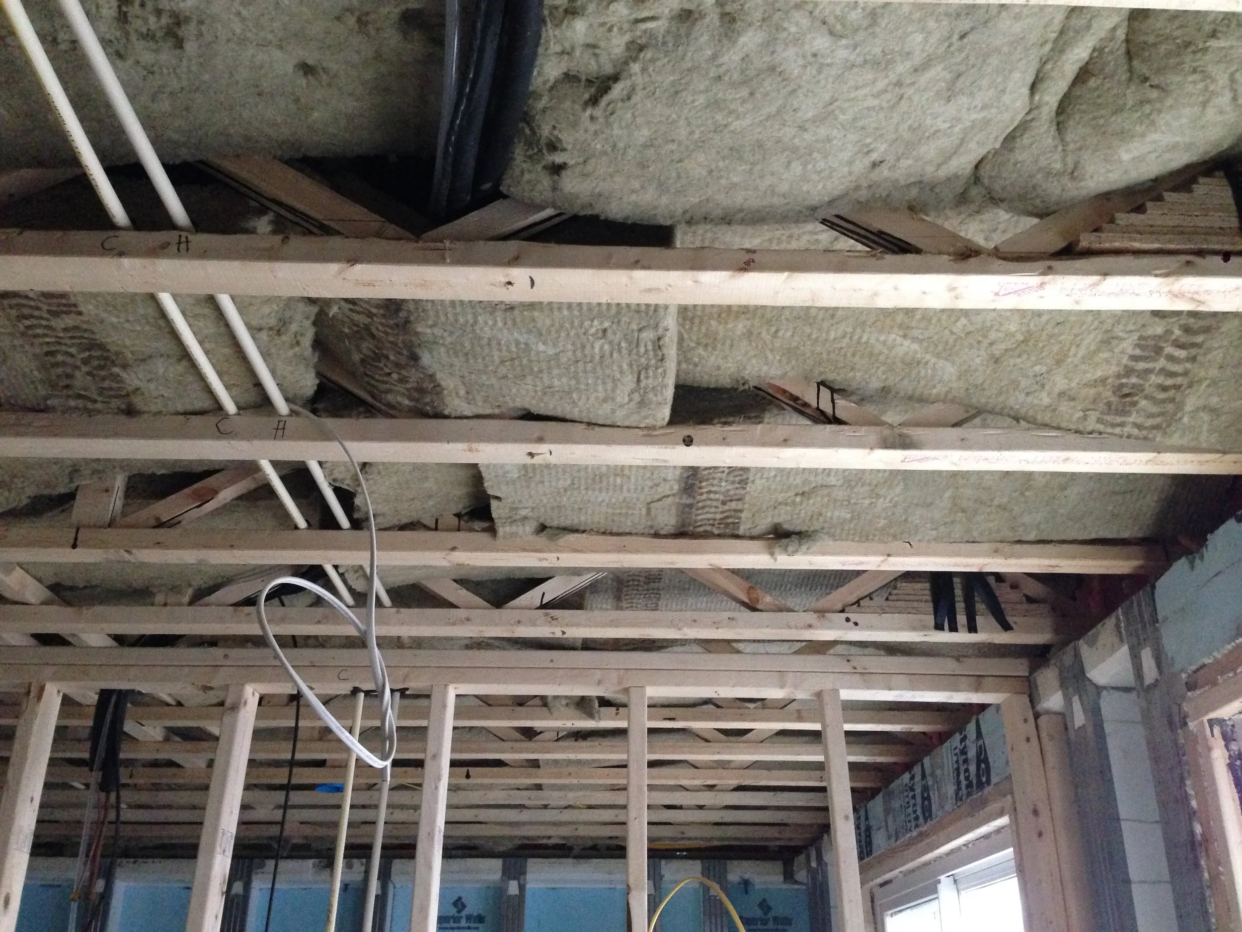 Sound proof insulation. Now that I look at the photo it seems that Rudy only did an okay job. Not as good and even as it should be. Every opening will let in sounds. Hopefully with this and once we put in the floor it should be really good sound wise from floor to floor.