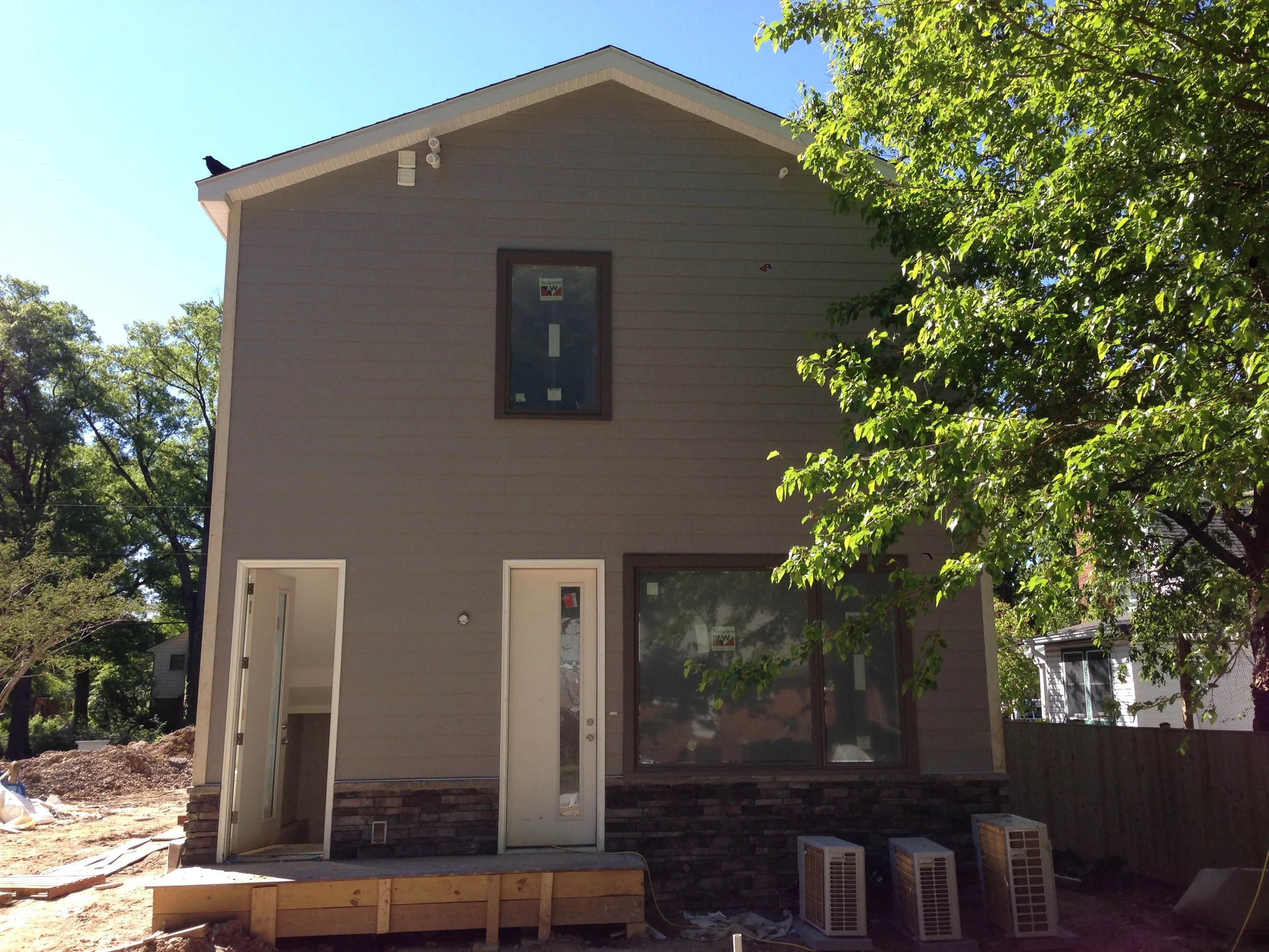 The side yard adjacent to the garage. We still have to paint the doors and their frames. Oh so close. 