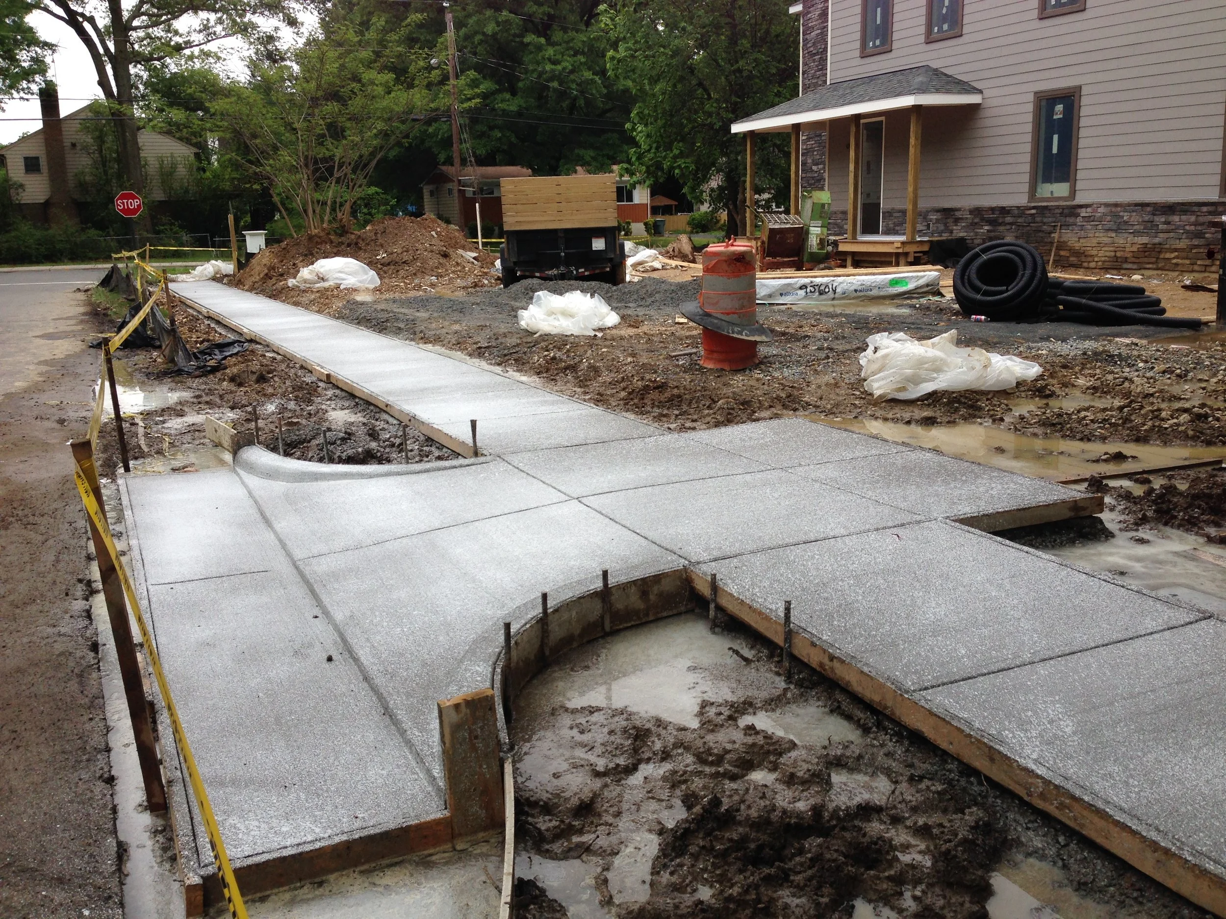 Concrete pour complete. Sidewalk and driveway installed! The entrance to the driveway is so small because we wanted to avoid the roots of the nearby Oak tree.