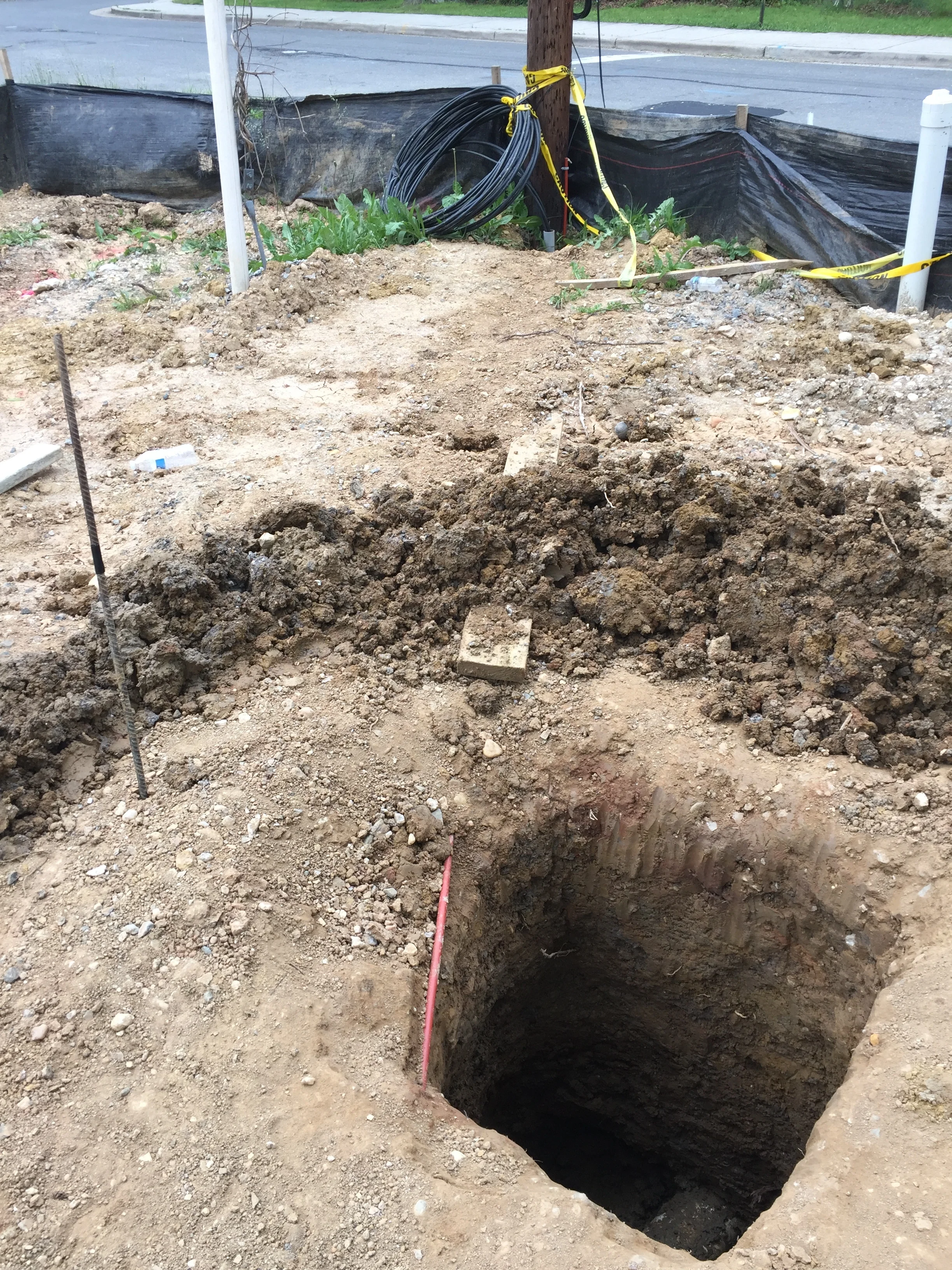 The storm drain is somewhere down there. About 48" down. We have to connect the roof drains directly to the storm drain. this was an extra $5k spent. This was an expense I realized at the time of getting my grading plans approved all thanks for the Chesapeake Bay.