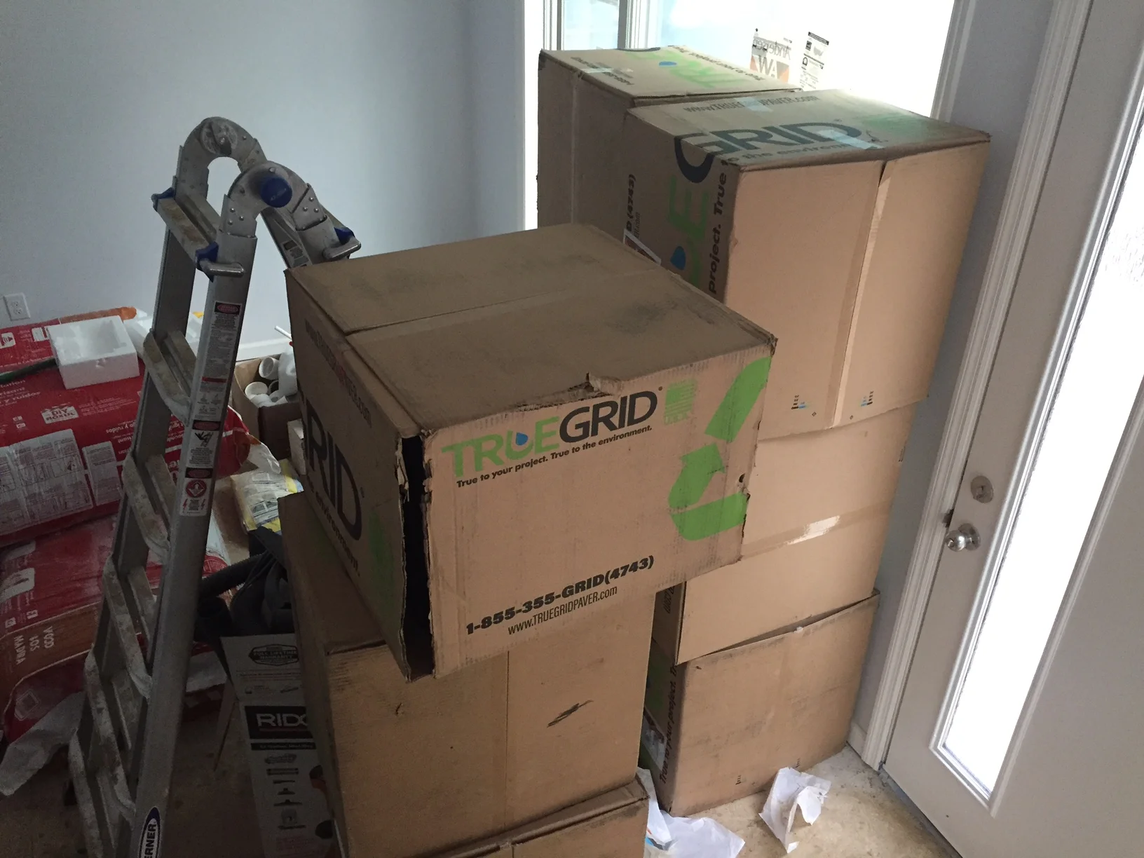 These boxes of True Grid will soon be my driveway. Very soon. As soon as the grading is completed. These are part of the pervious system. This cost us a cool $1,100. Once you add in the gravel and some labor it will cost around $2,000 for the driveway. Not bad. 