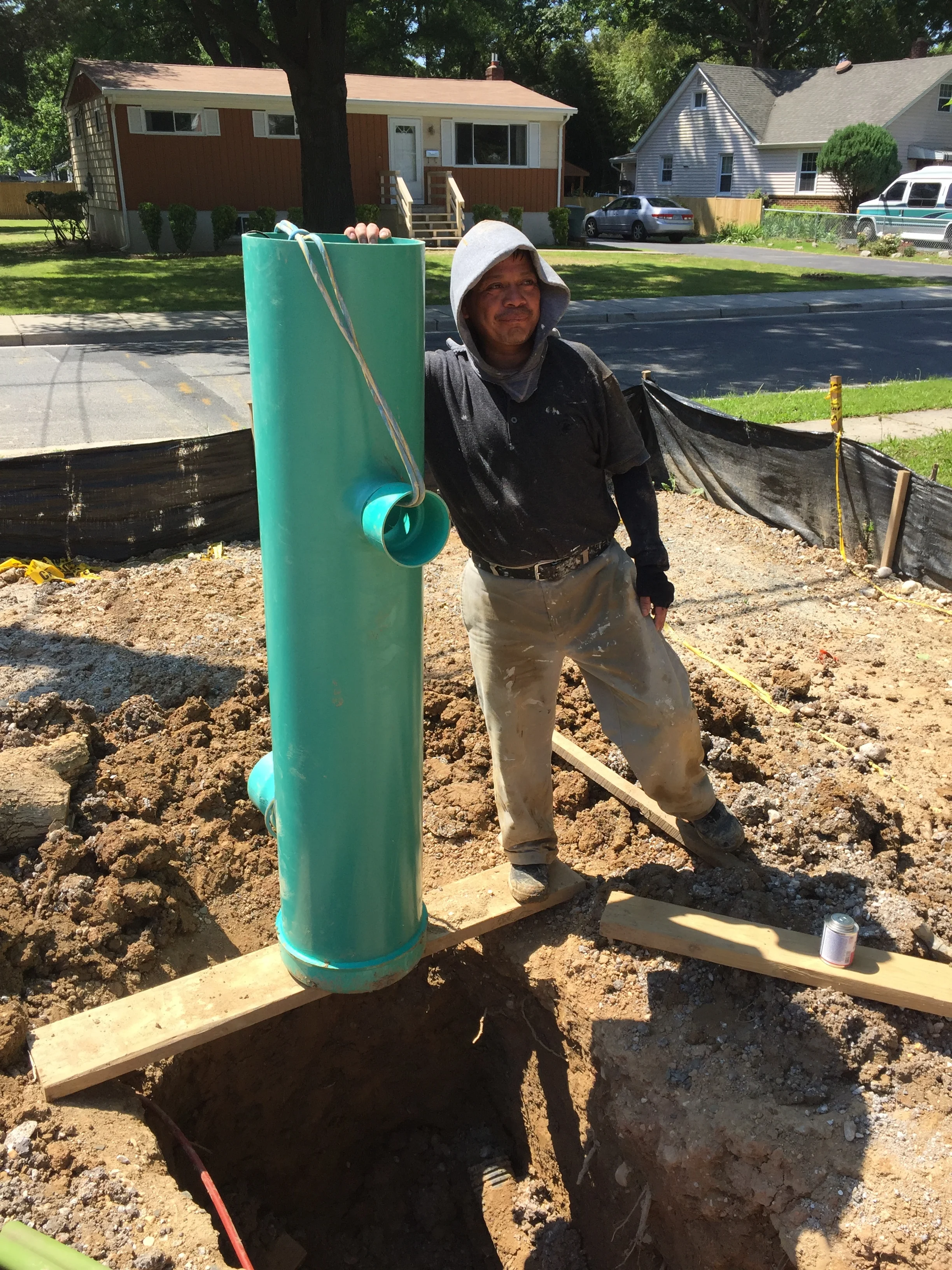 The 12" Nyloplast drain and Rudy. All the house water will drain into the 4" connection up top and exit at the 6" connection going to the main storm drain line. The drain is over 5' tall. 