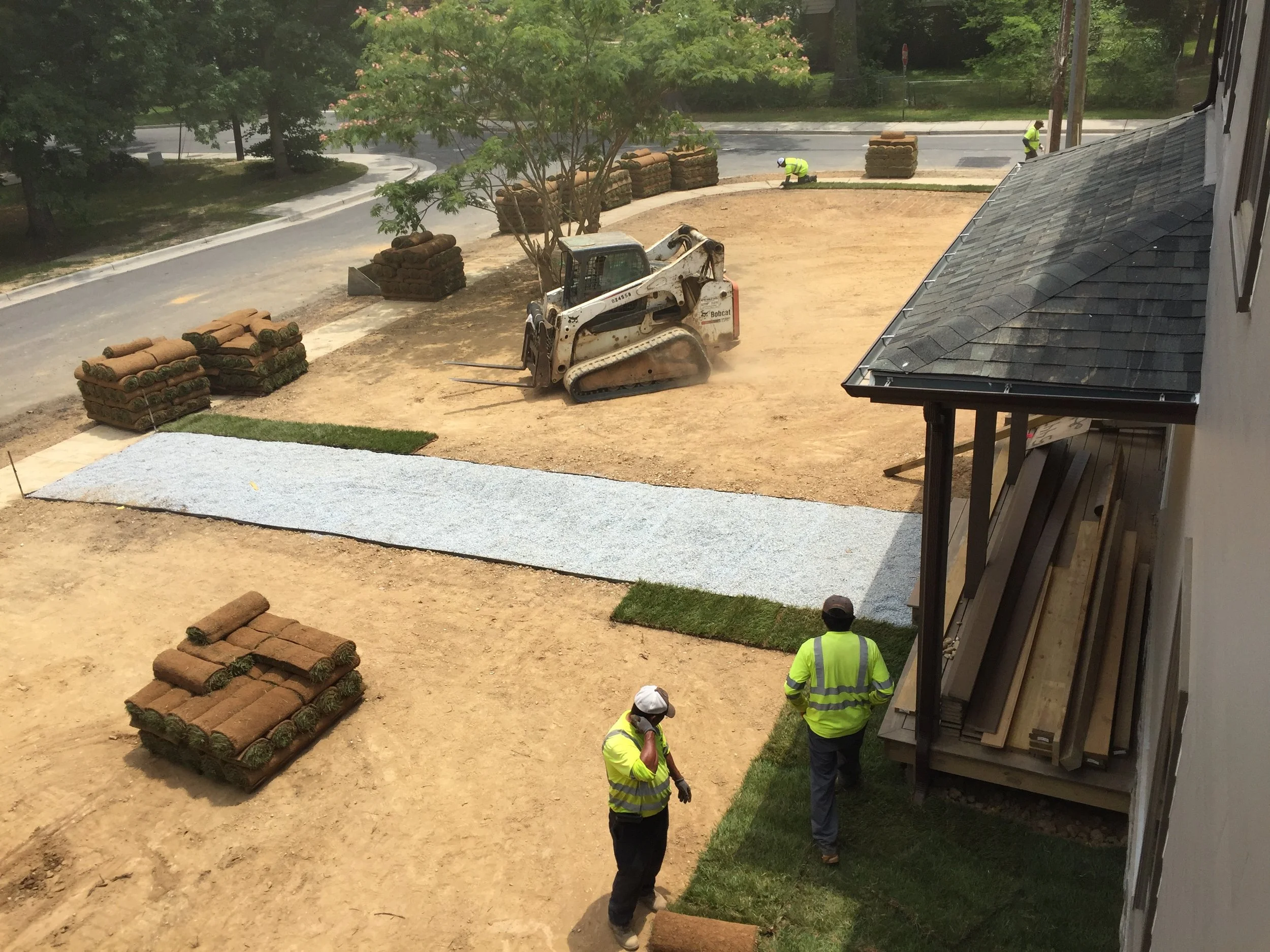 Sod starting to get placed after the morning crew cleaned the site. Notice how smooth the dirt looks. 