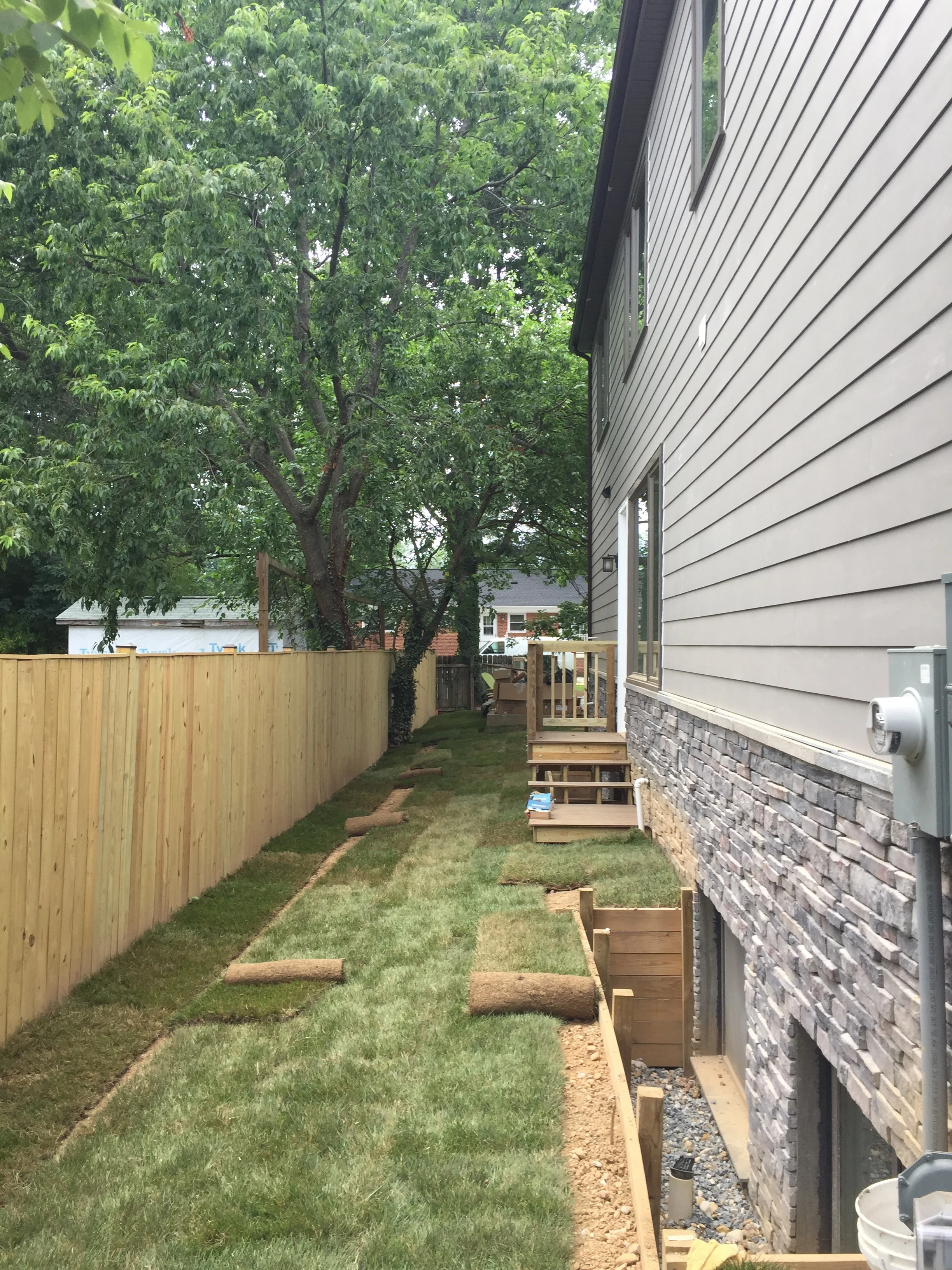 Sod being installed along the side yard. The sad part is that I have to fix the window wall retaining wall so I will have to rip up some grass and replace some wood. Lesson learned. 