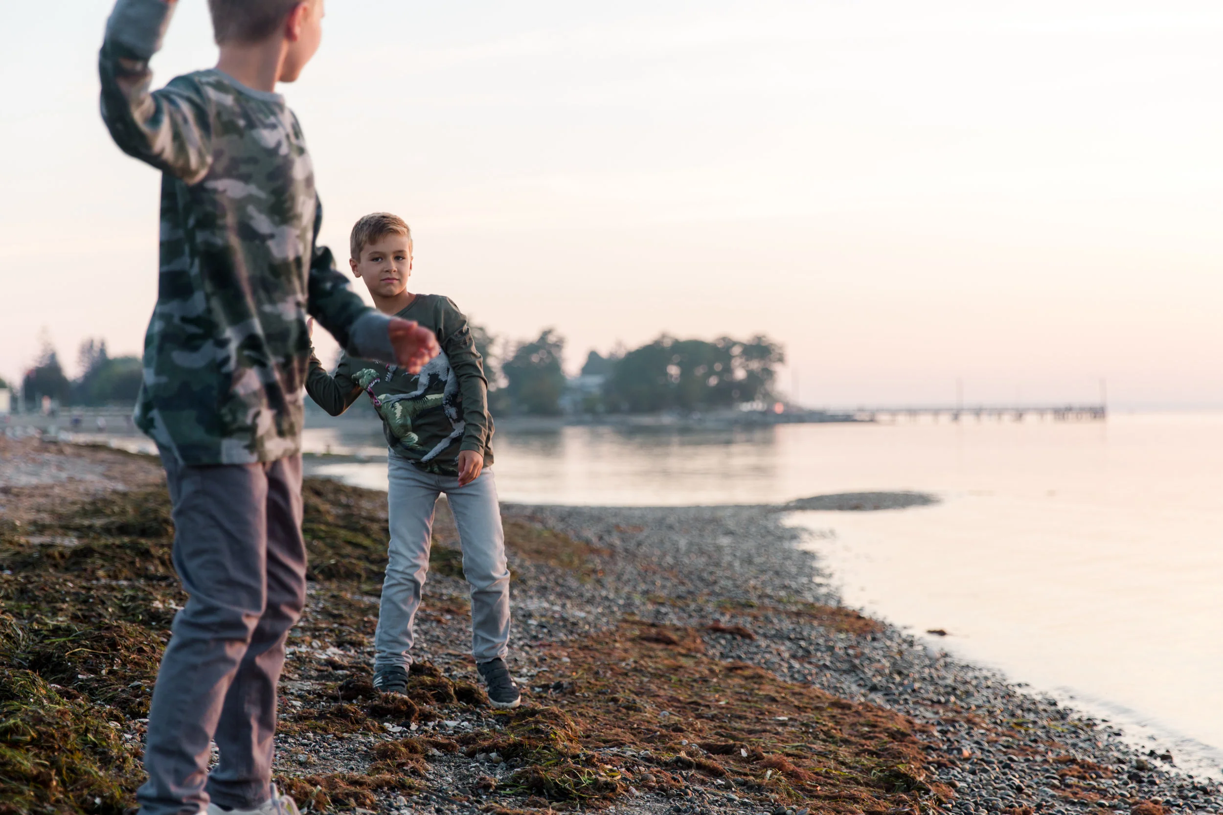 boys throwing rocks at the beach in south surrey