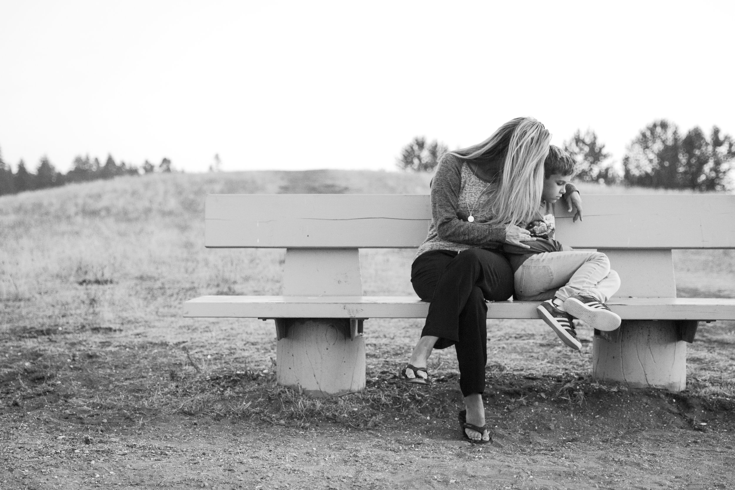 mom comforting son at photo session at blackie spit in surrey