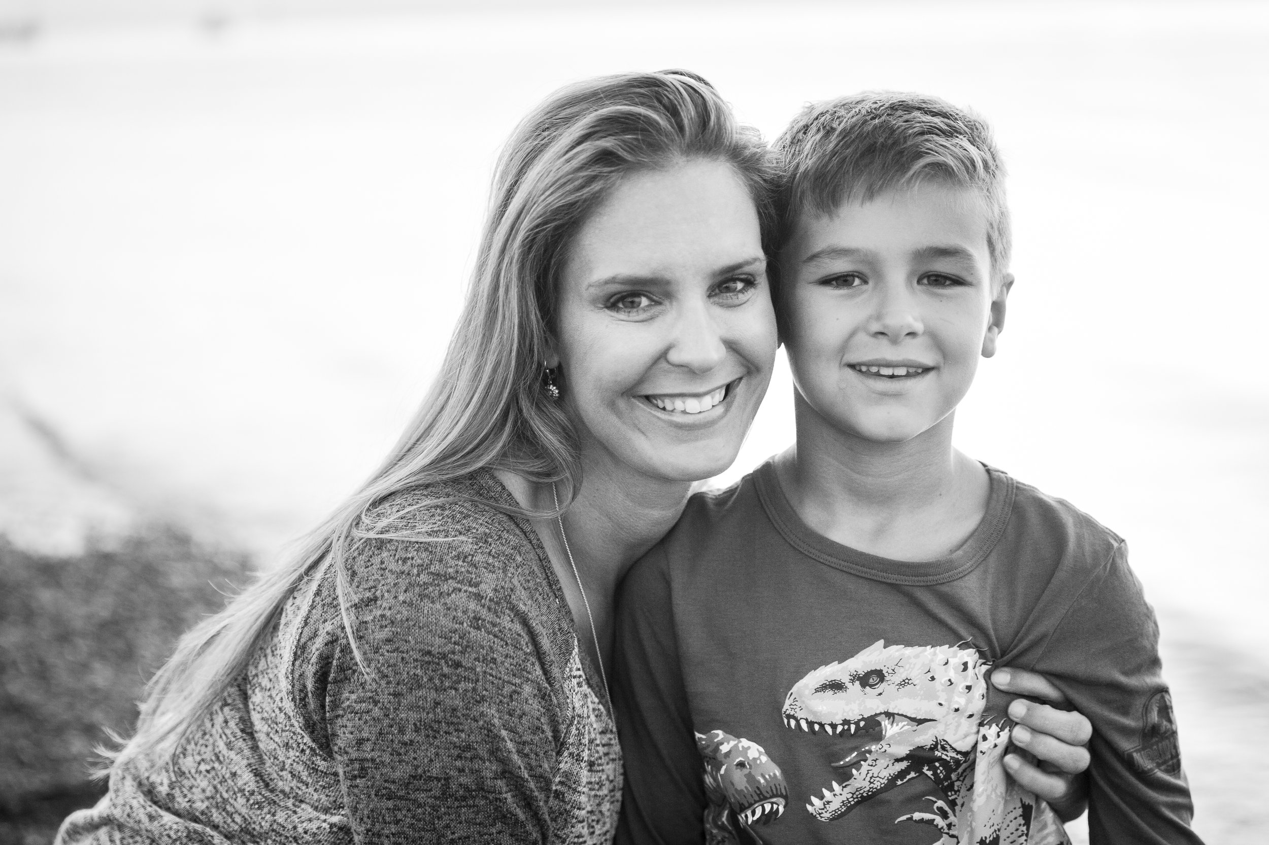 mom and her boy posing on the beach in surrey