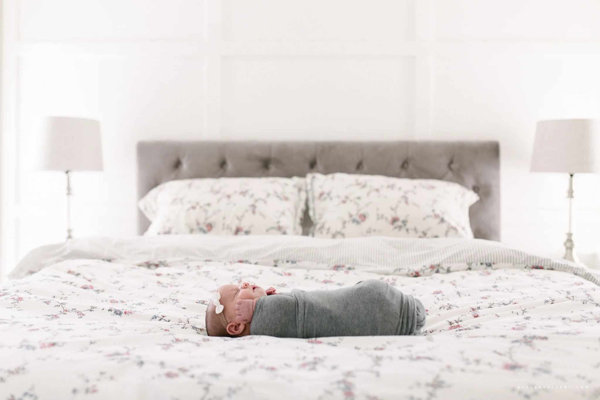 baby girl lying on bed during photo session