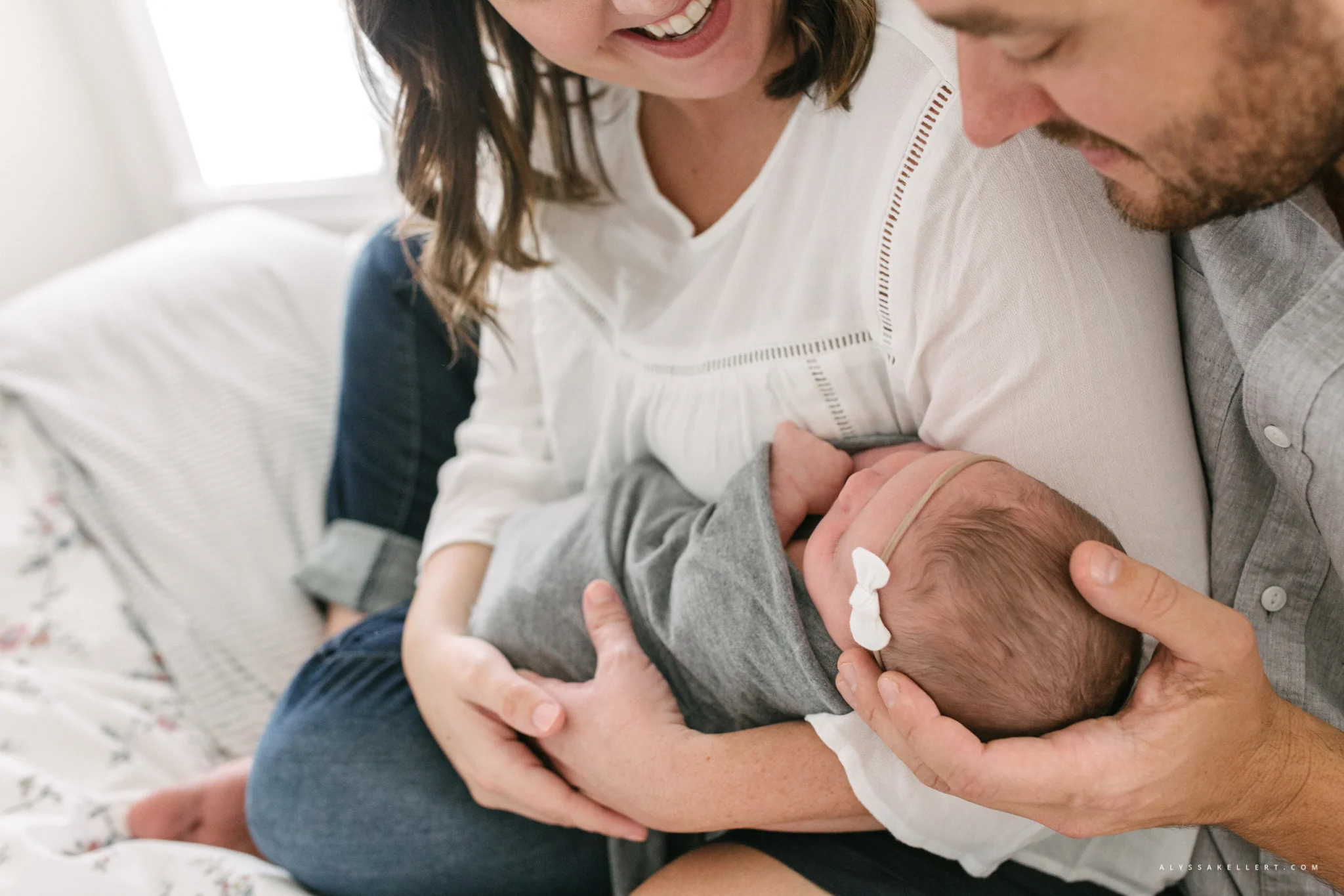mom and dad staring at baby girl