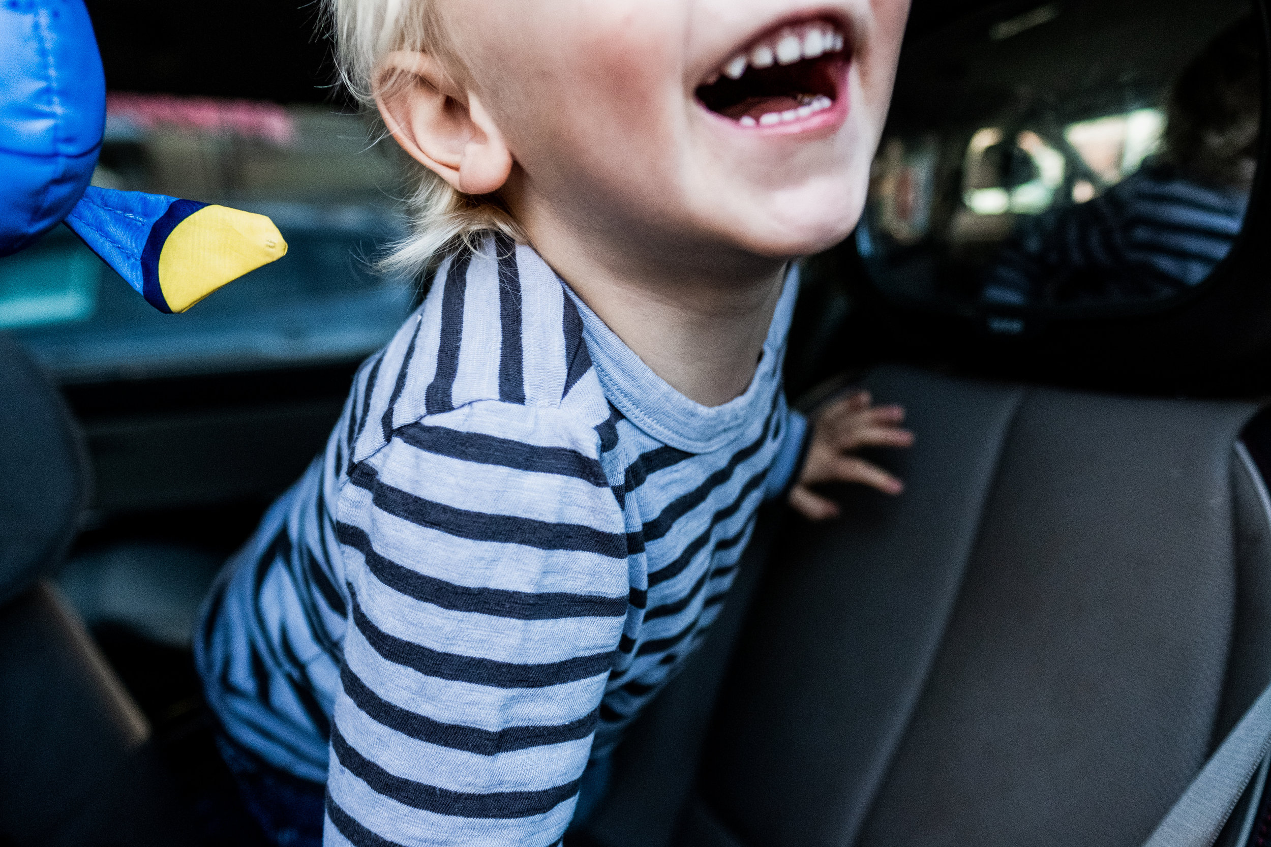 boy-in-car-smile-open-mouth-carseat-toddler