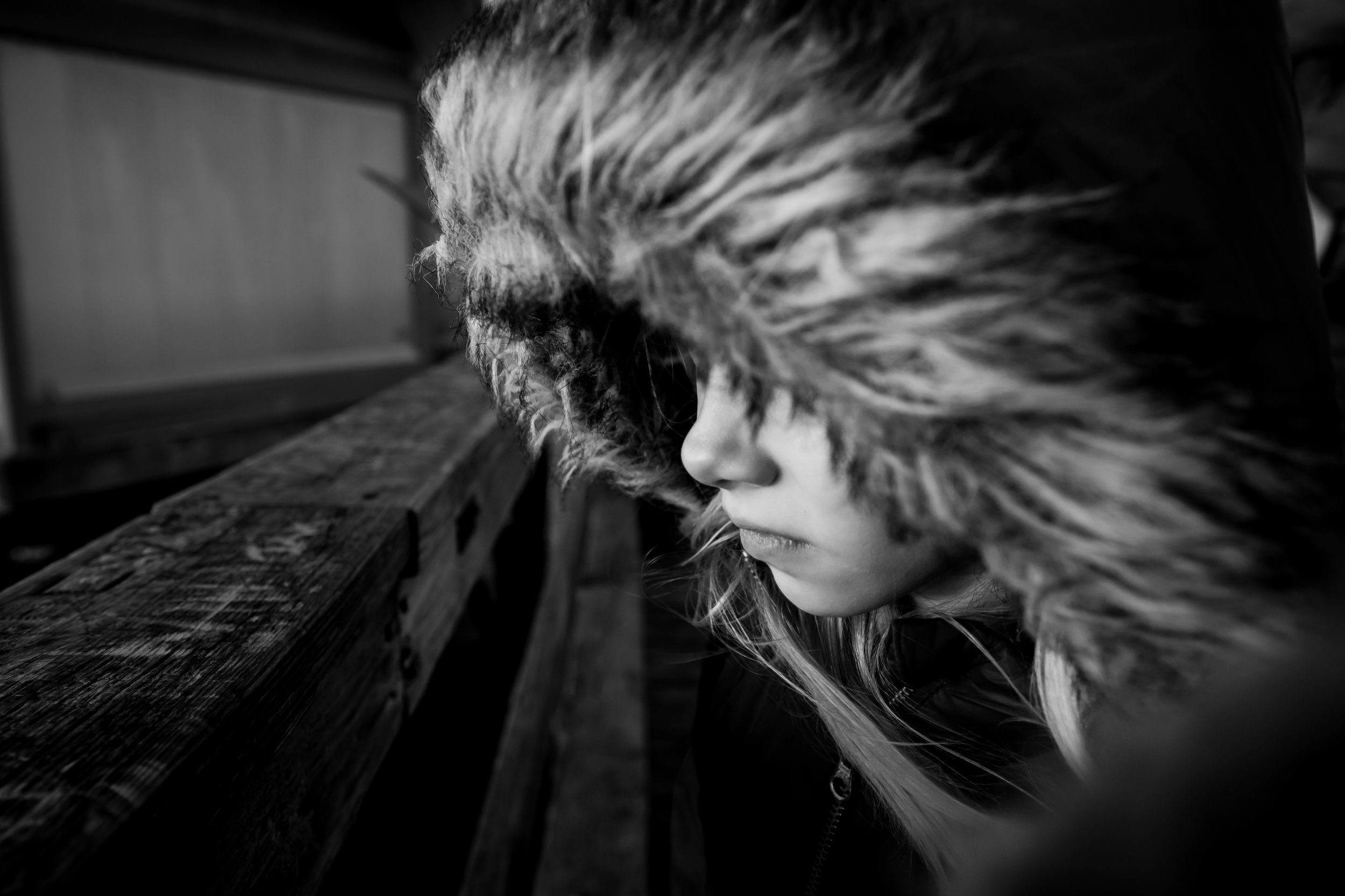 girl in furry hood looking out 