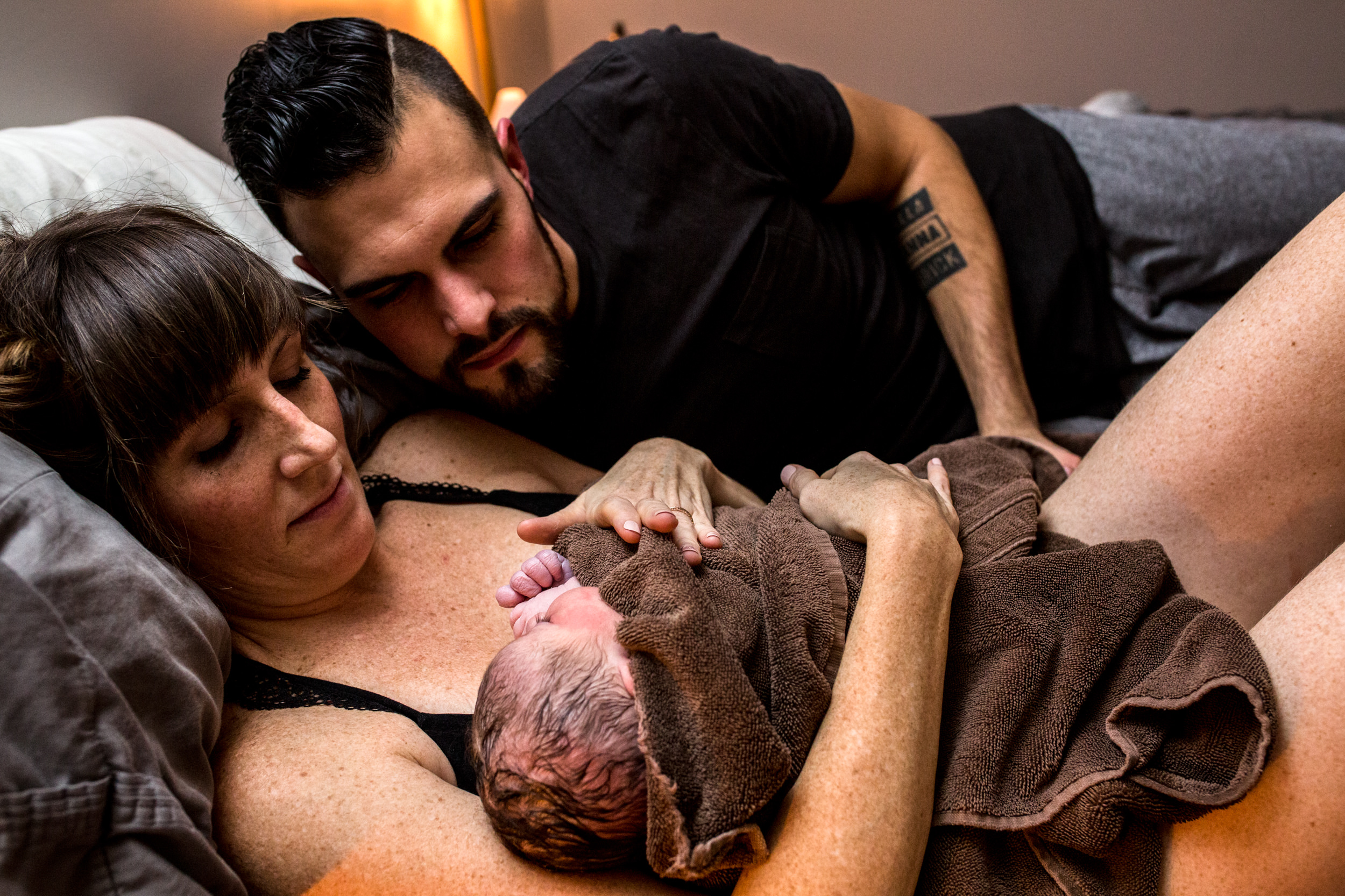 parents looking down at baby girls face