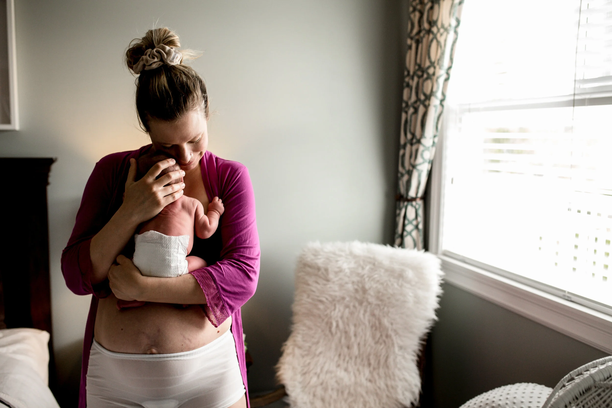 woman-hugging-newborn-baby-standing.jpg